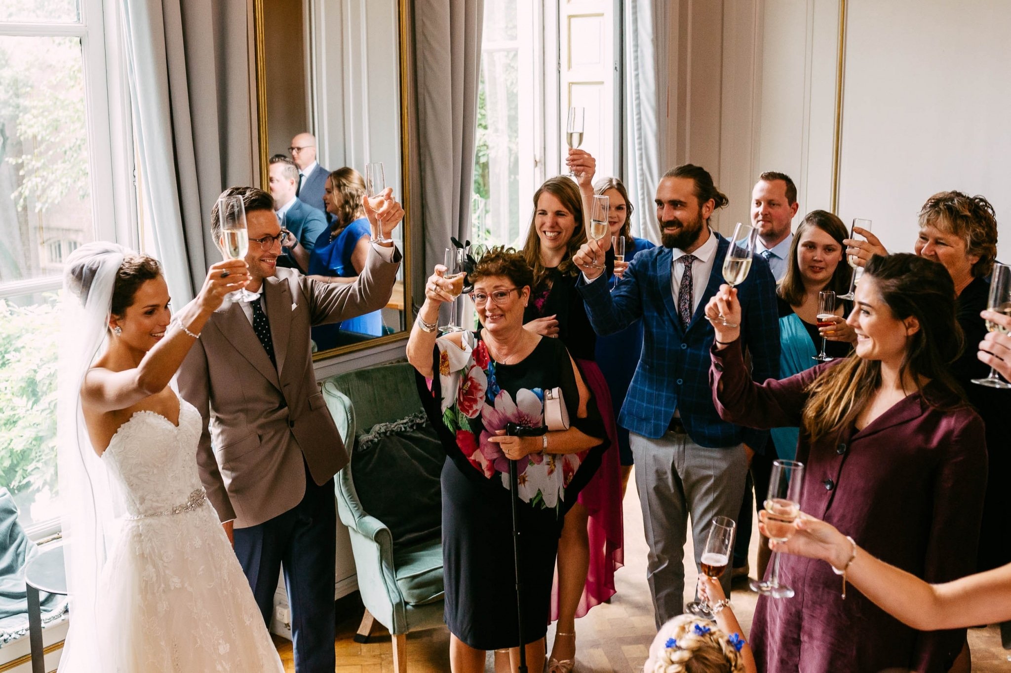 A group of people toast at a wedding reception.