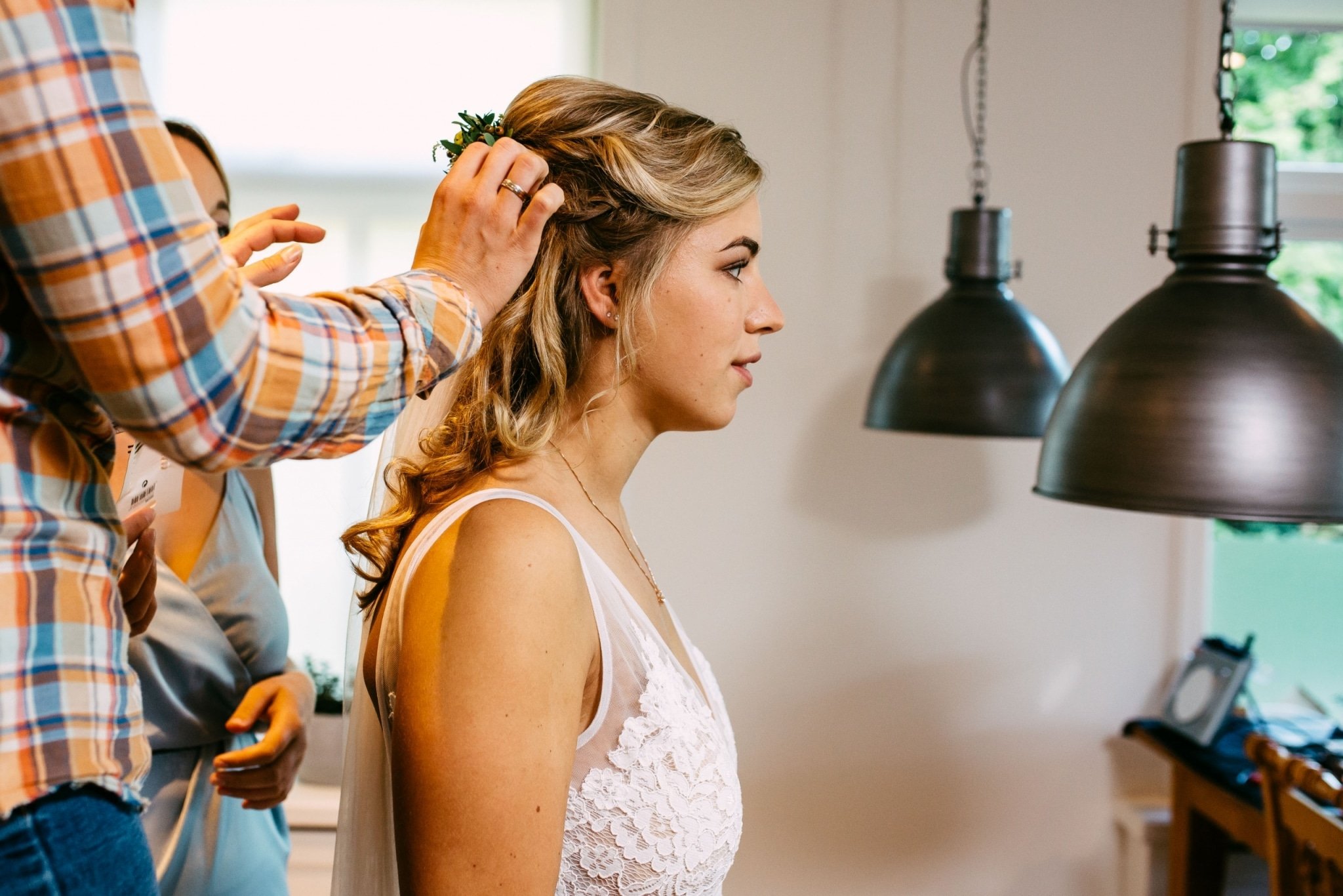 A bride having her hair done by a hairdresser.