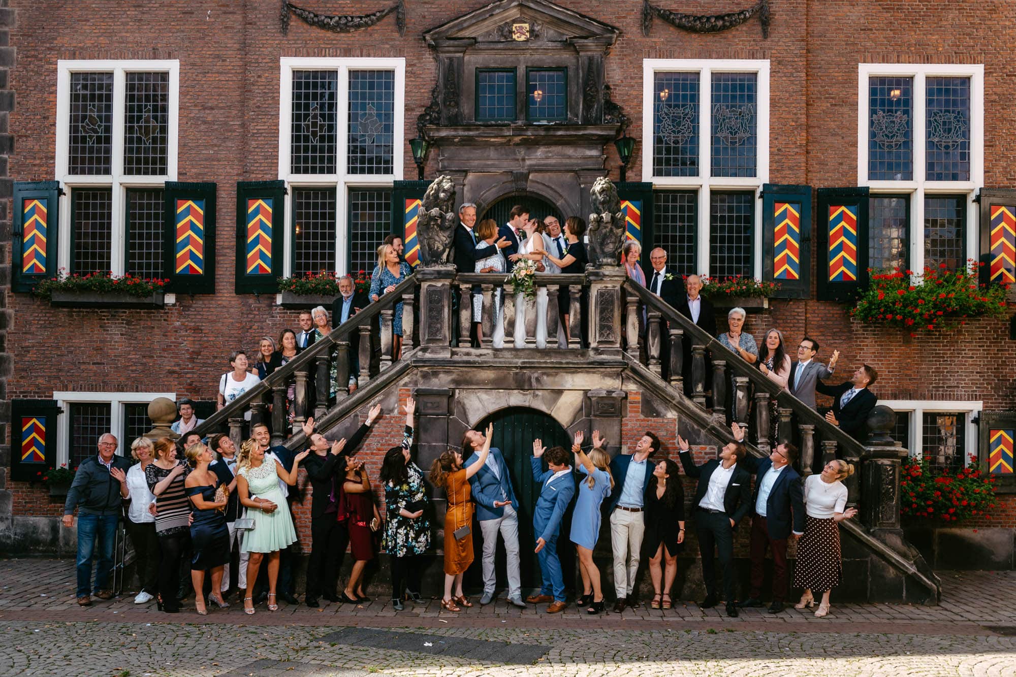 A group of people pose in front of a building.