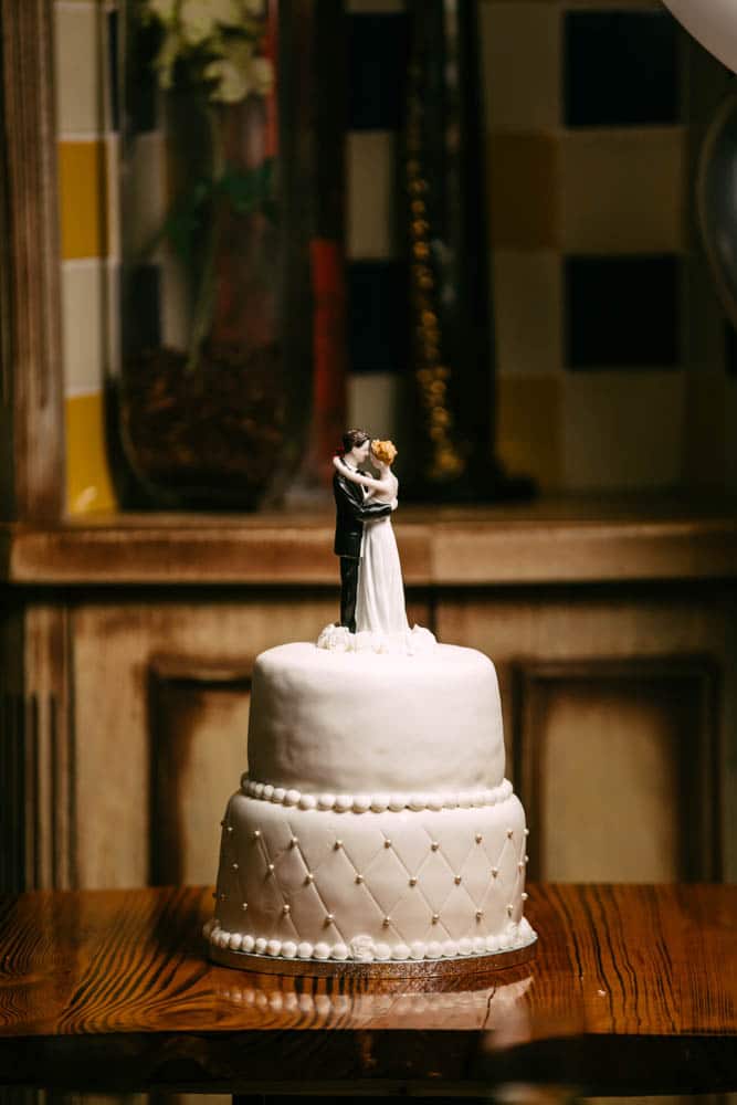 A beautiful wedding cake decorated with a bride and groom, exuding wedding inspiration.