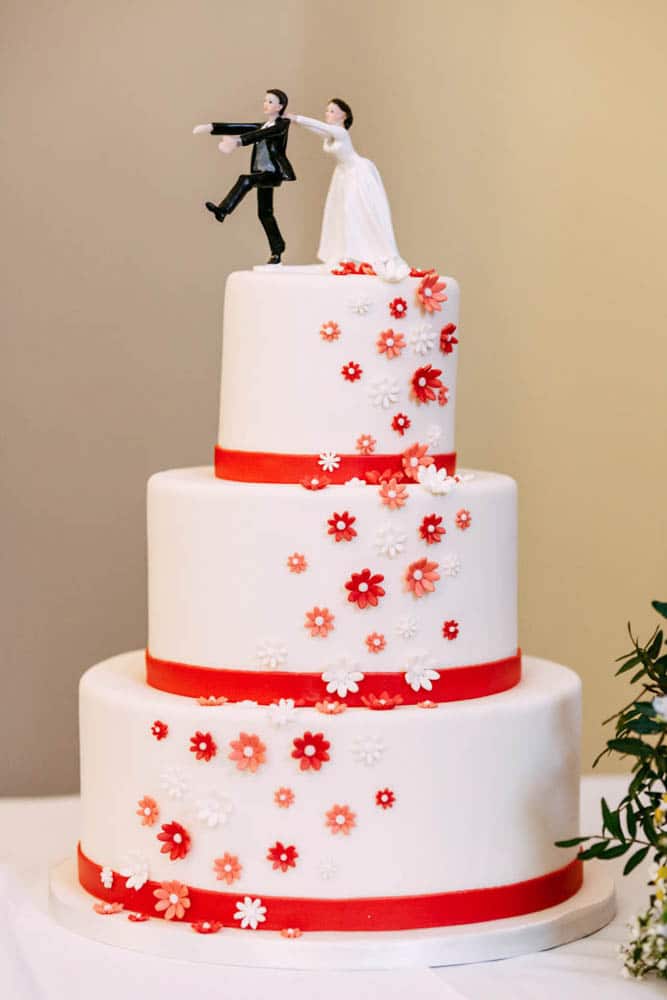 Wedding inspiration featuring a bride and groom on top of the wedding cake.