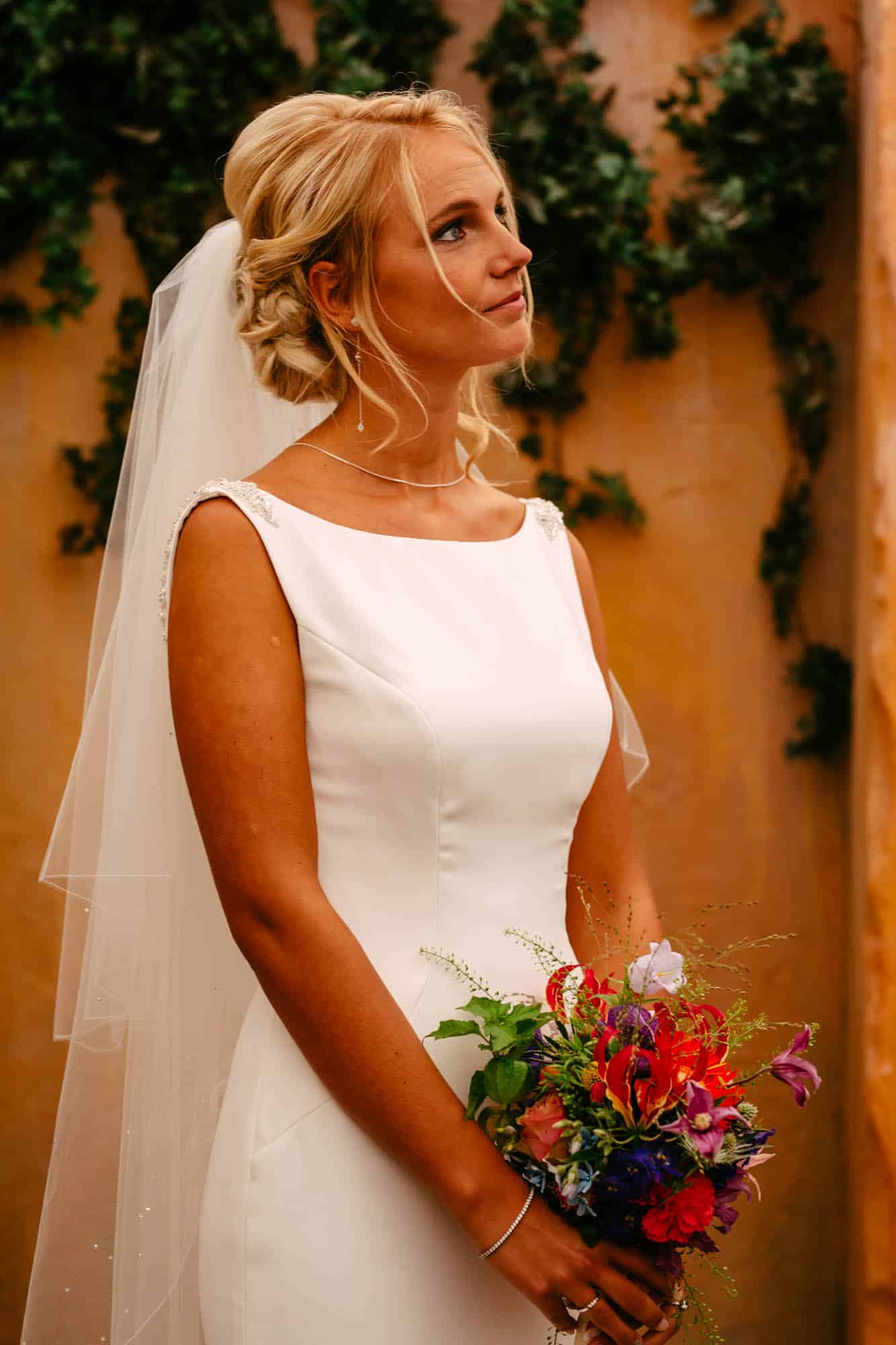 A bride in a white wedding dress with a bouquet.