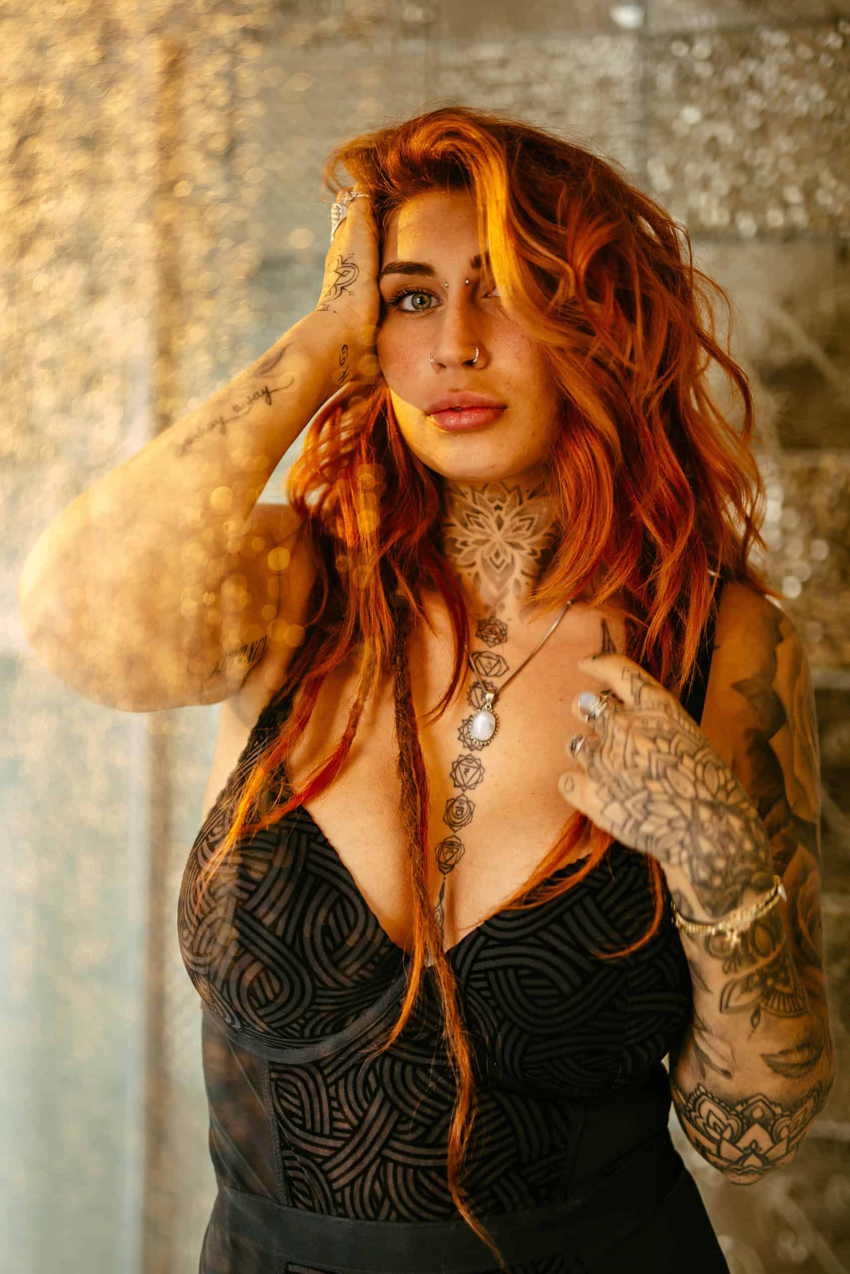 A woman with tattoos on her body enjoys a boudoir shoot in Hoek van Holland.