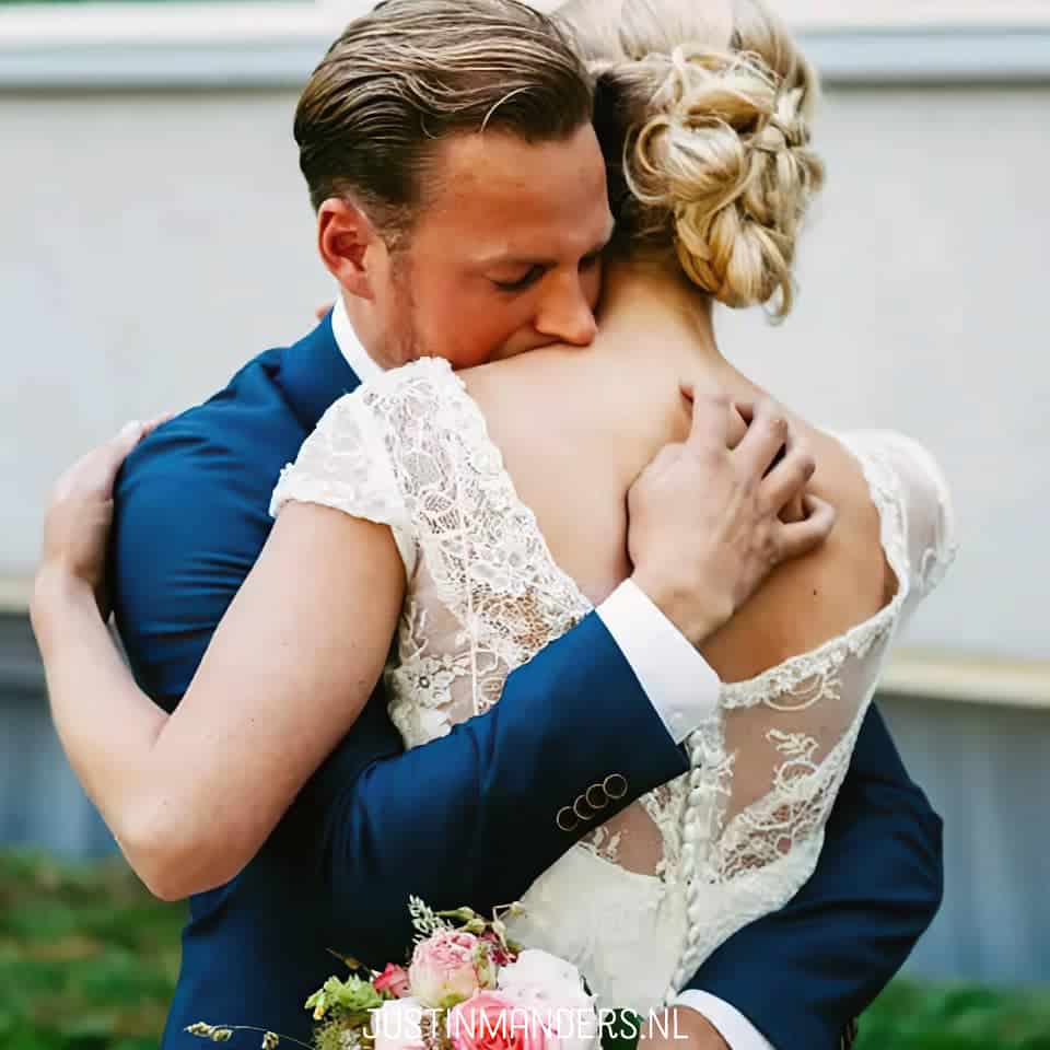 A bride and groom embracing each other at their wedding.