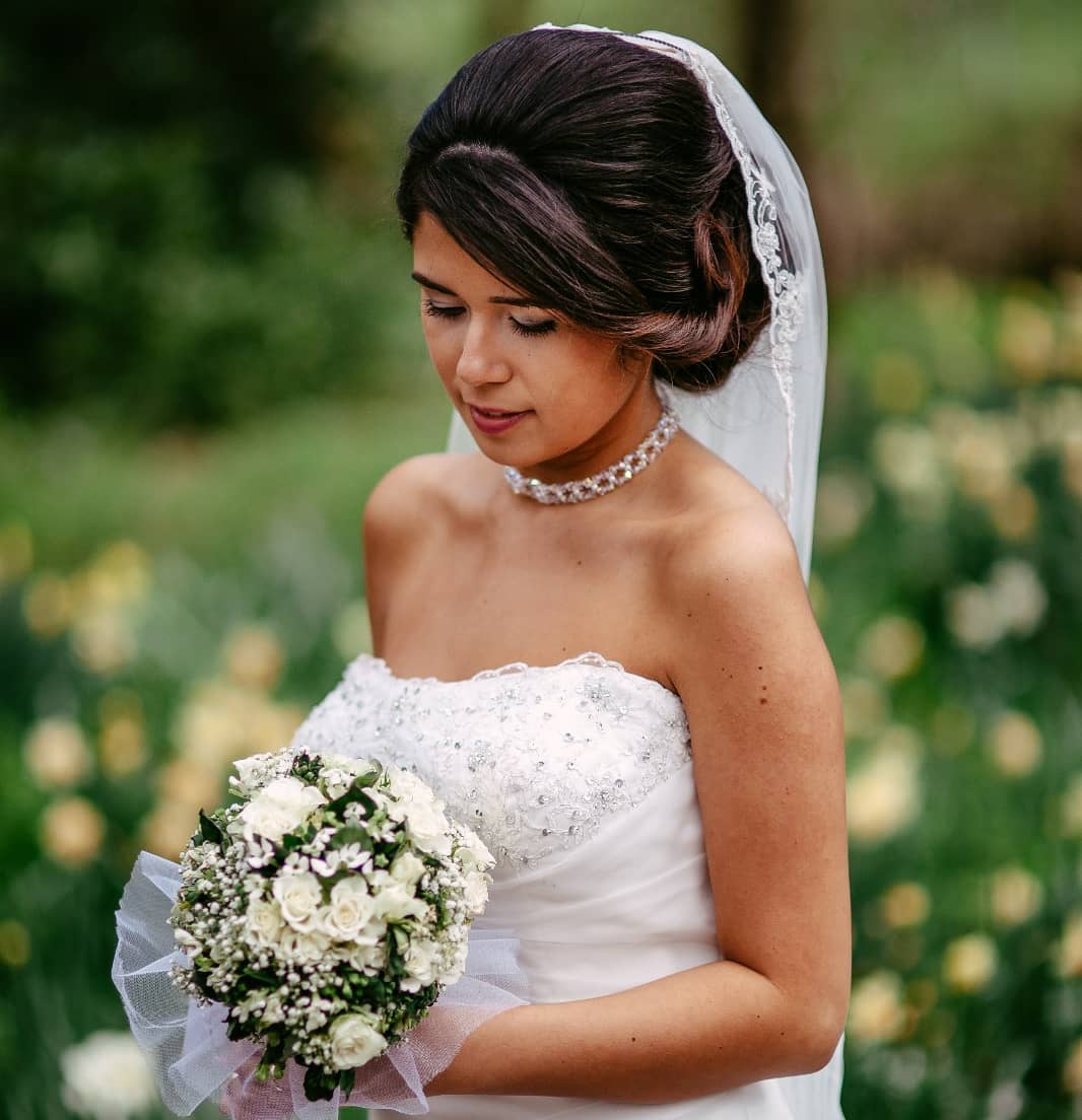     Een bruid in trouwjurk met een boeket in haar handen, vastgelegd door een getalenteerde trouwfotograaf en gedeeld op Instagram.