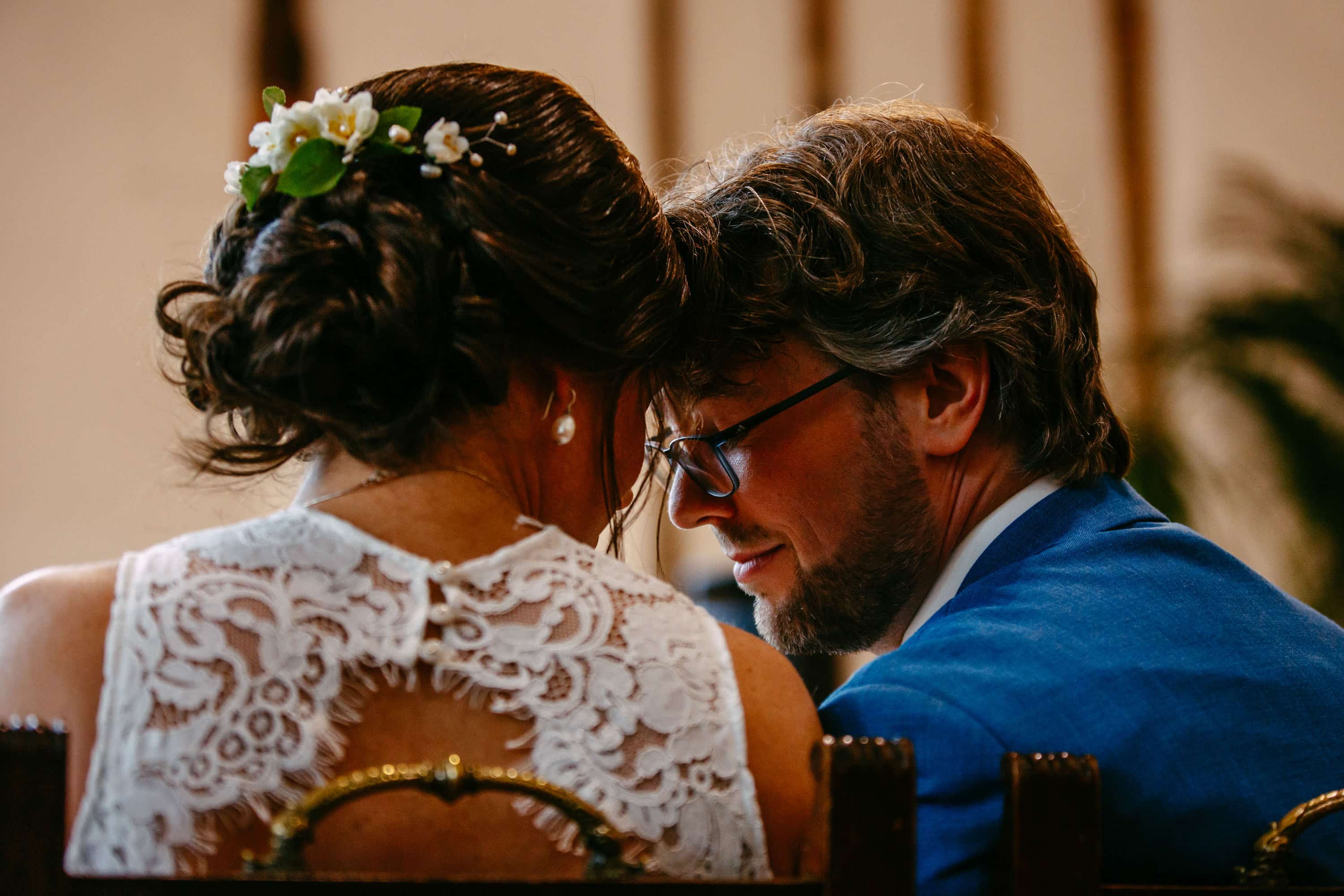 A bride and groom looking at each other during their wedding ceremony.