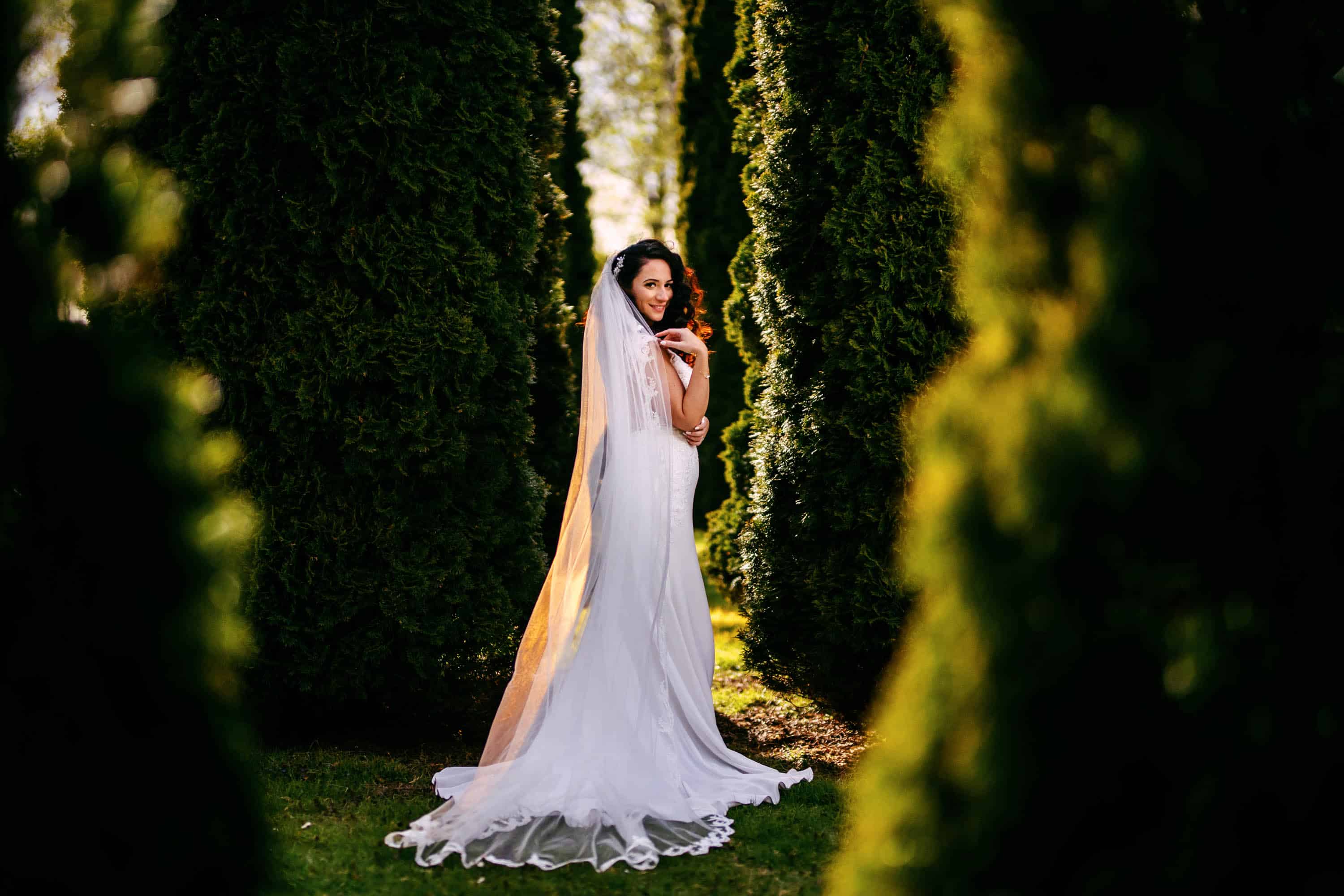 A bride posing in the middle of a forest.