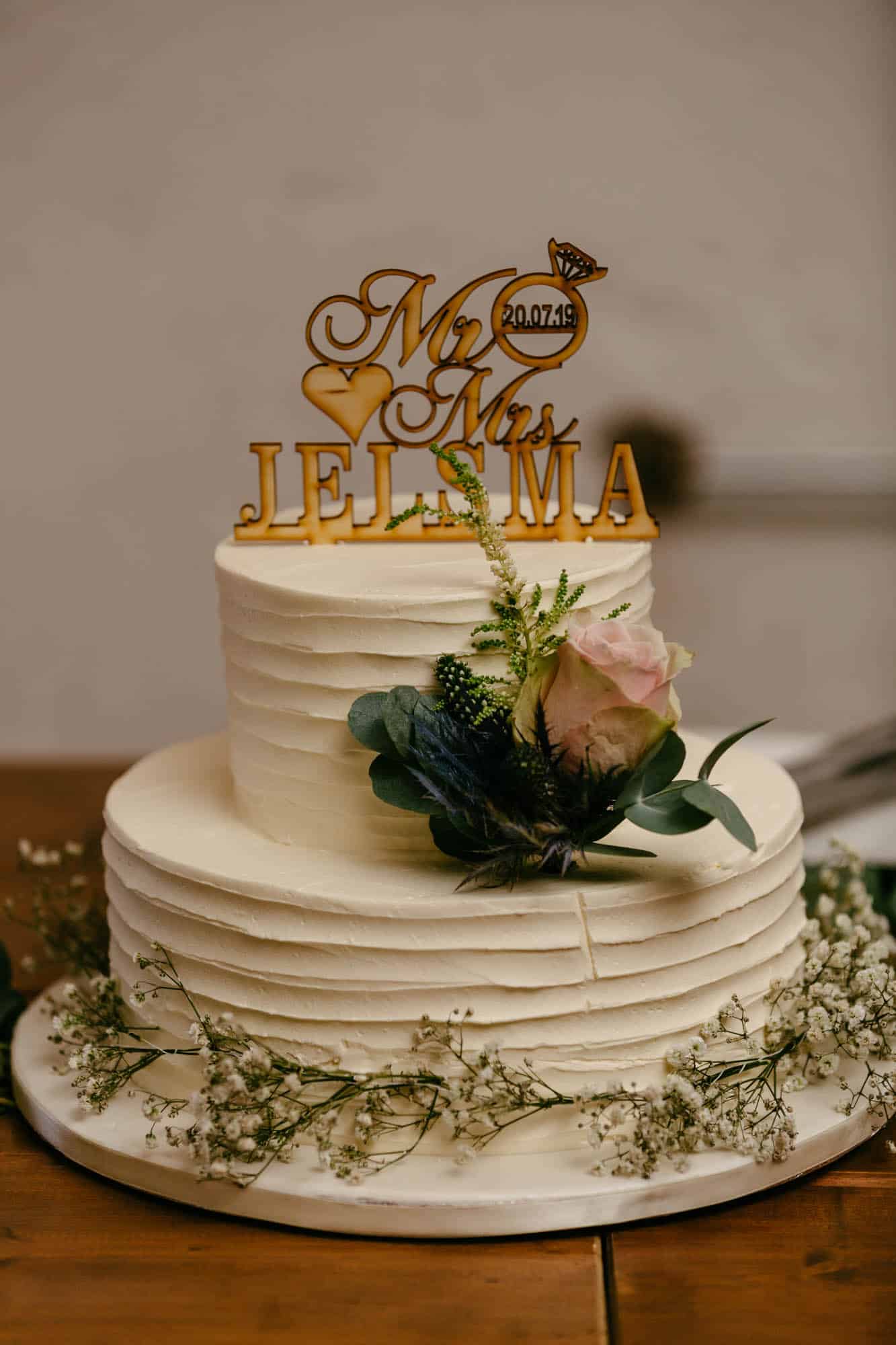 A wedding cake with a wedding cake topper.