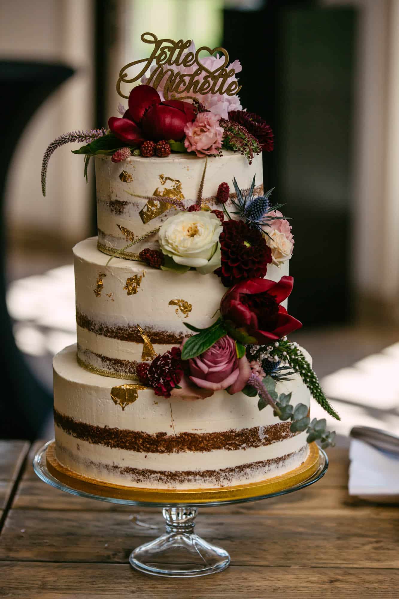Naked wedding cake with edible gold leaf