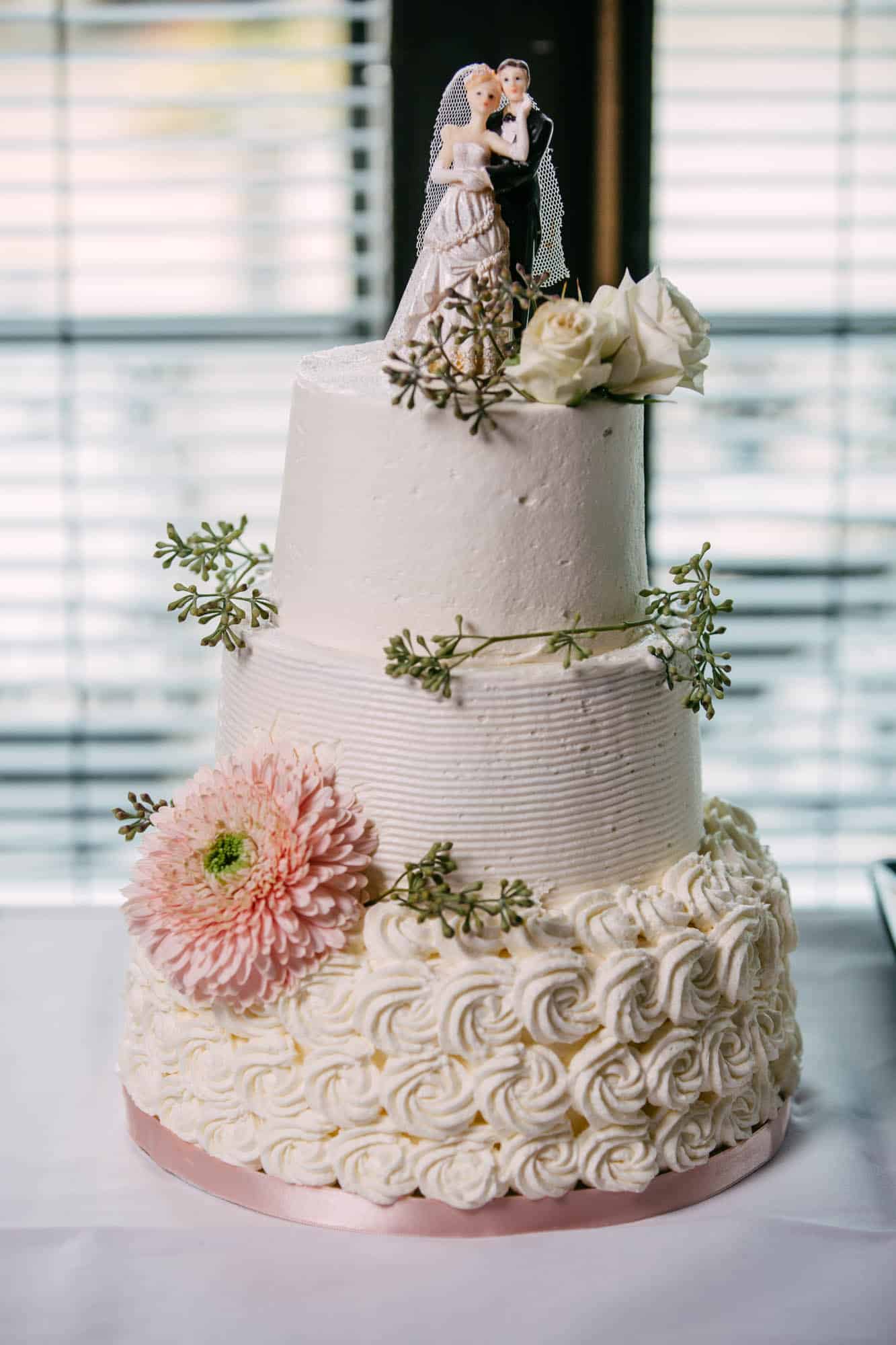 White wedding cake with topper