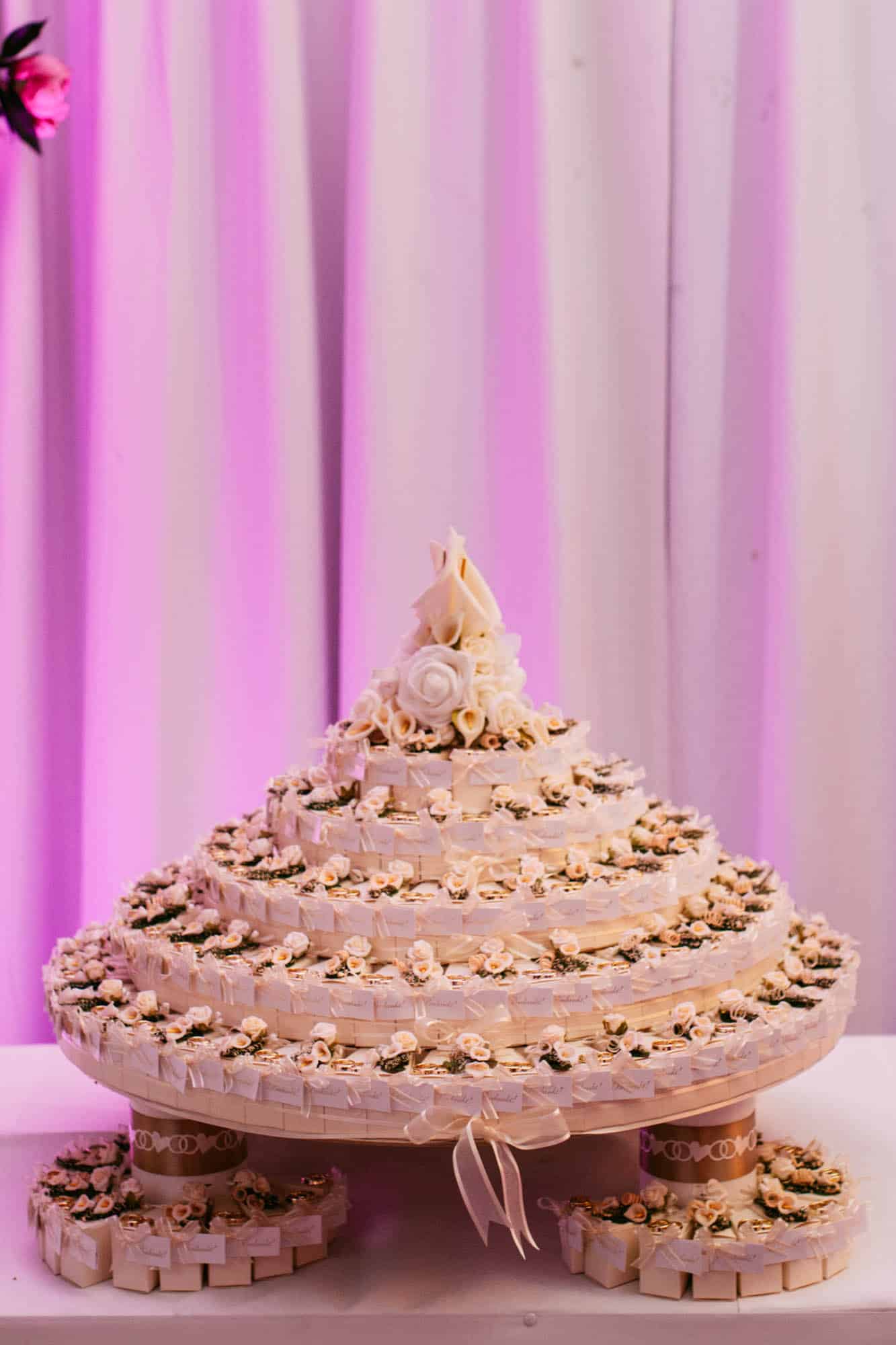 A wedding cake sits atop a table.