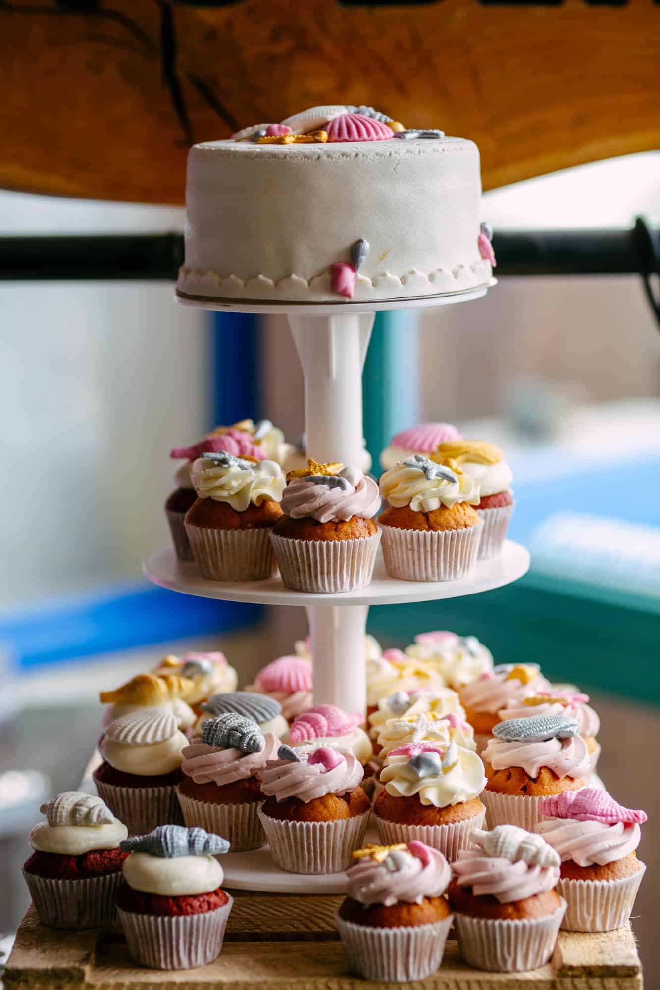 A cake stand with wedding cakes on it.