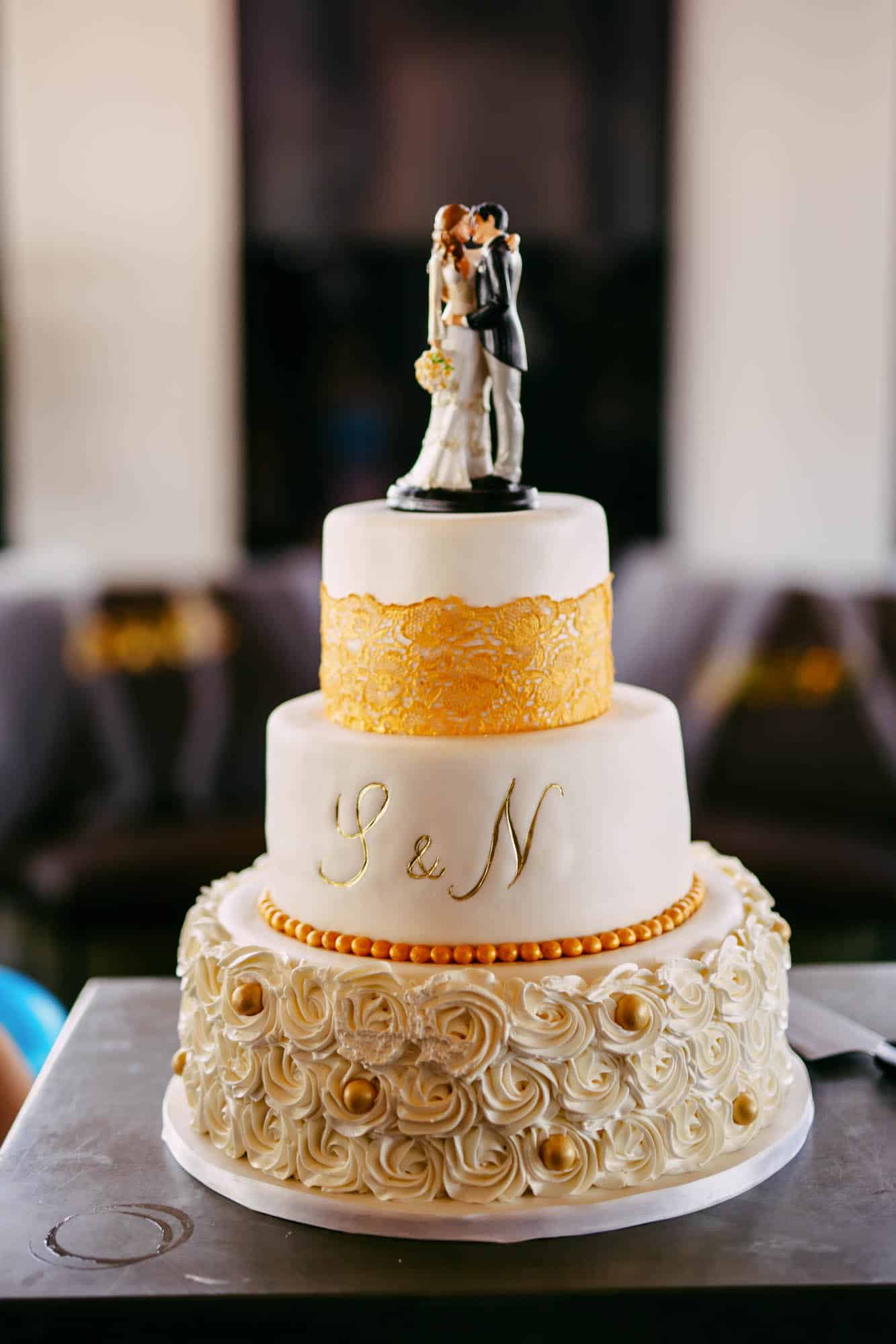         Description: A wedding cake with a couple on top.