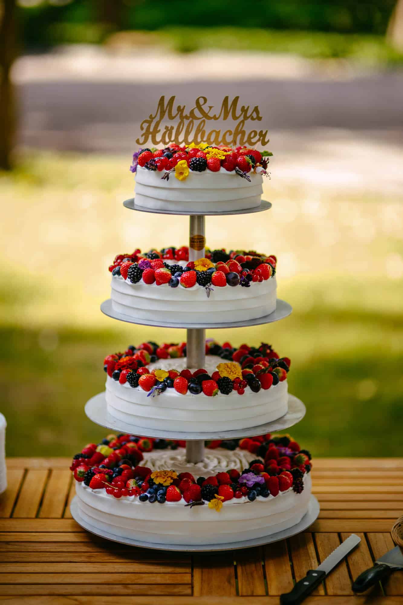 A wedding cake with berries on top.