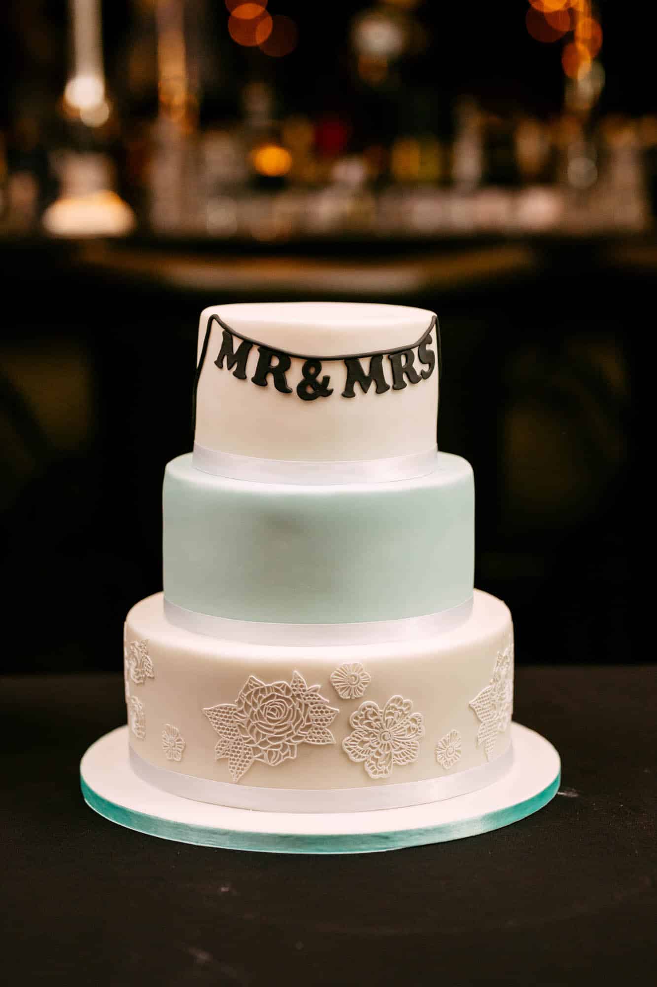 Description: A wedding cake with the words mr and mrs on it.