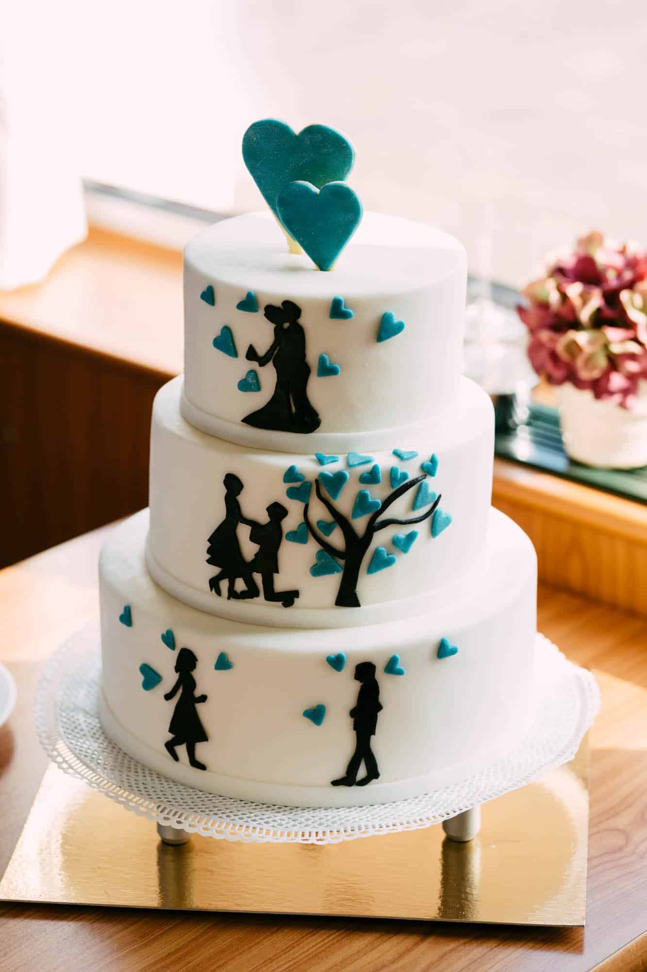 A wedding cake with silhouette of a couple.