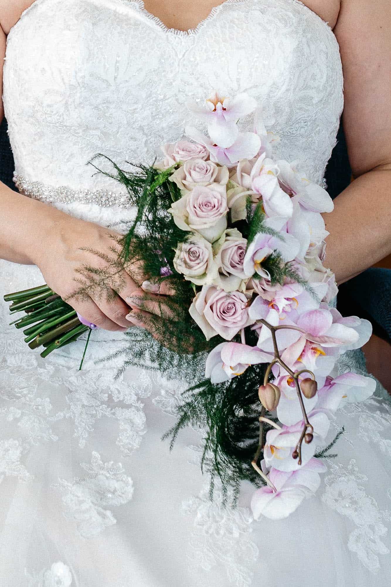 A bride in wedding dress with a wedding bouquet.