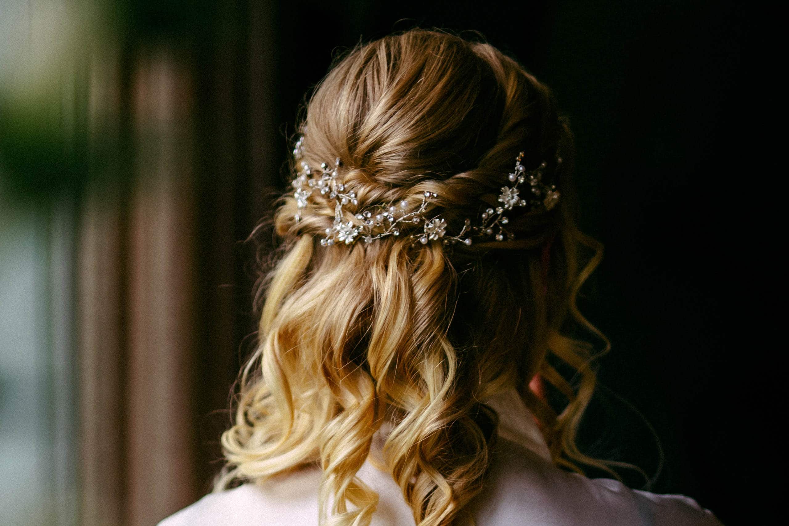 A gorgeous bridal hairstyle with a delicate floral accent.