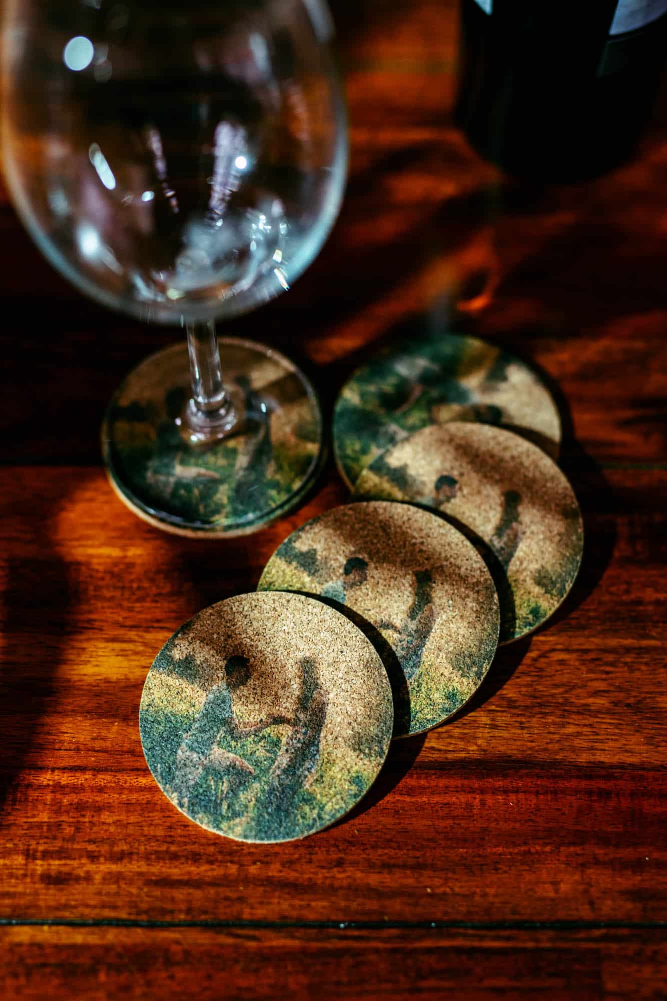 A perfect wedding day gift: four coasters with a picture of a couple sitting on a table.