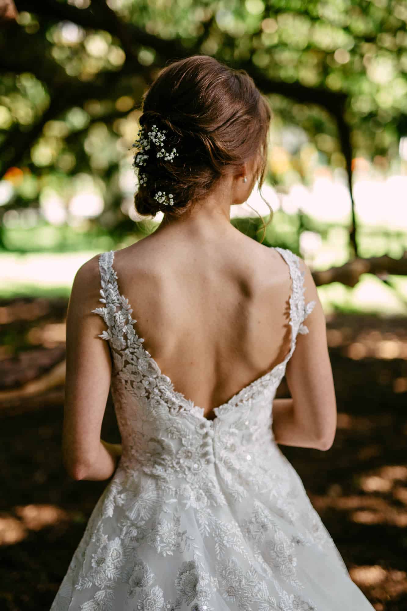 The back of a bride in an A-line wedding dress.