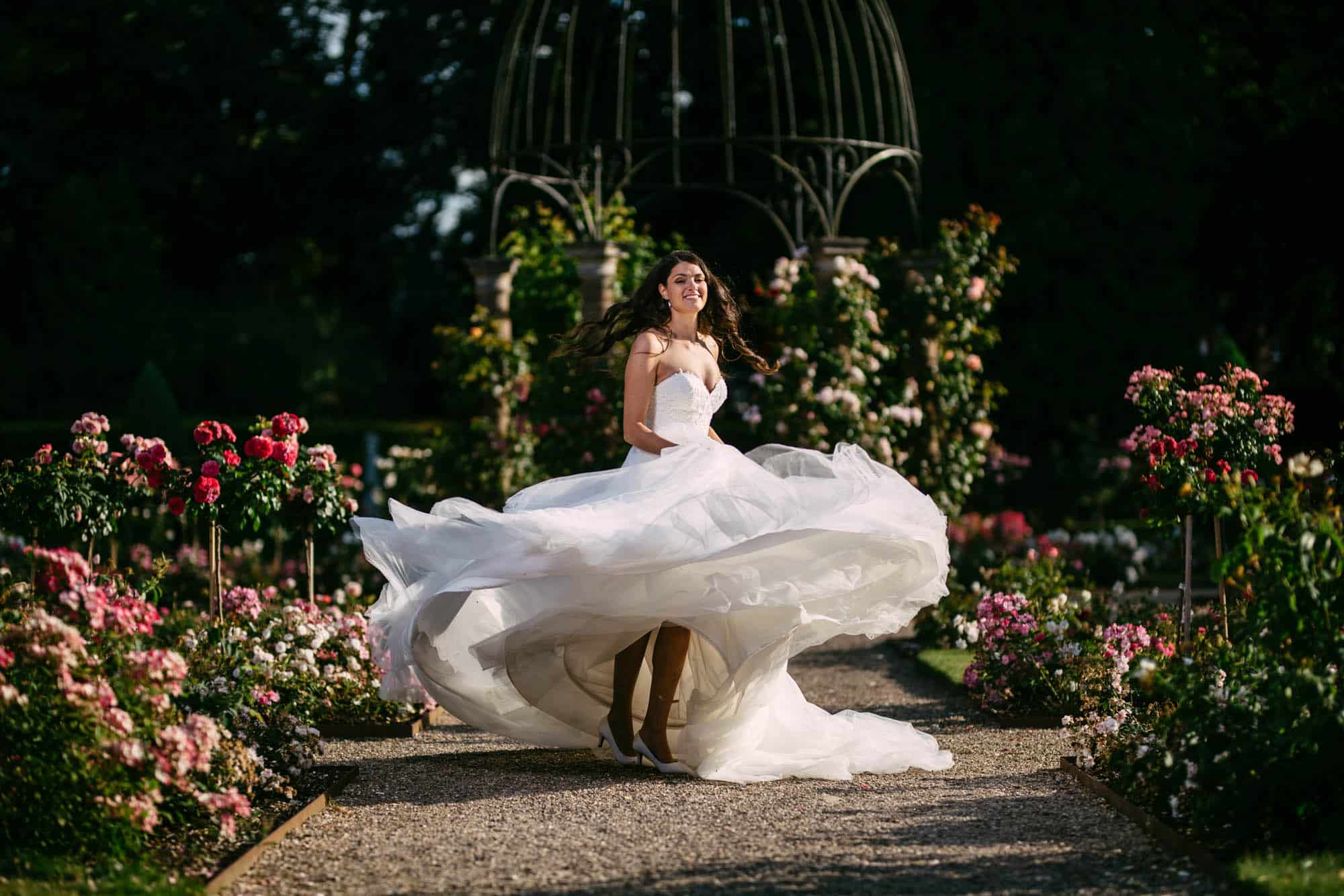 A bride in an A-line wedding dress in a garden.