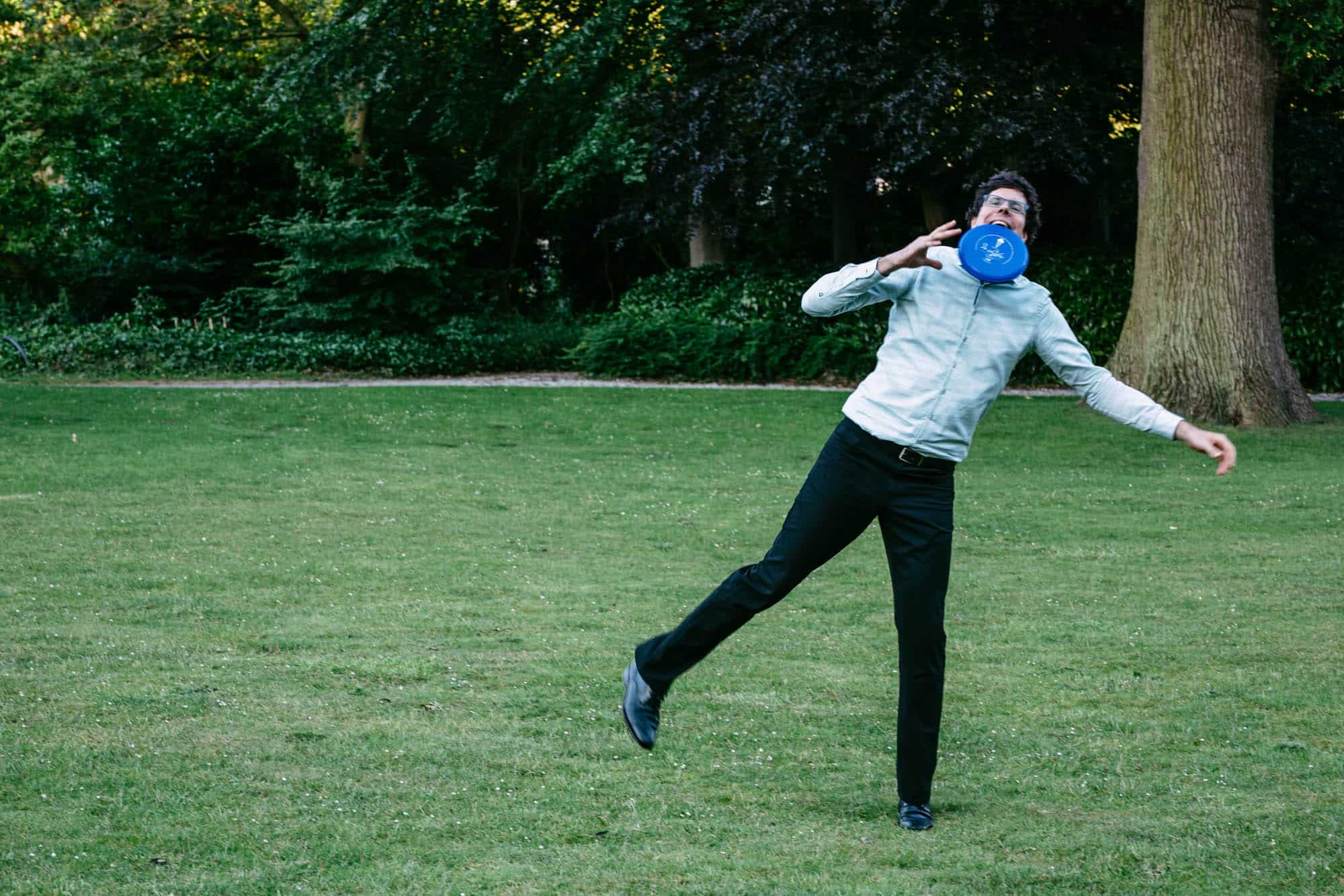 A man plays with a frisbee in a park.