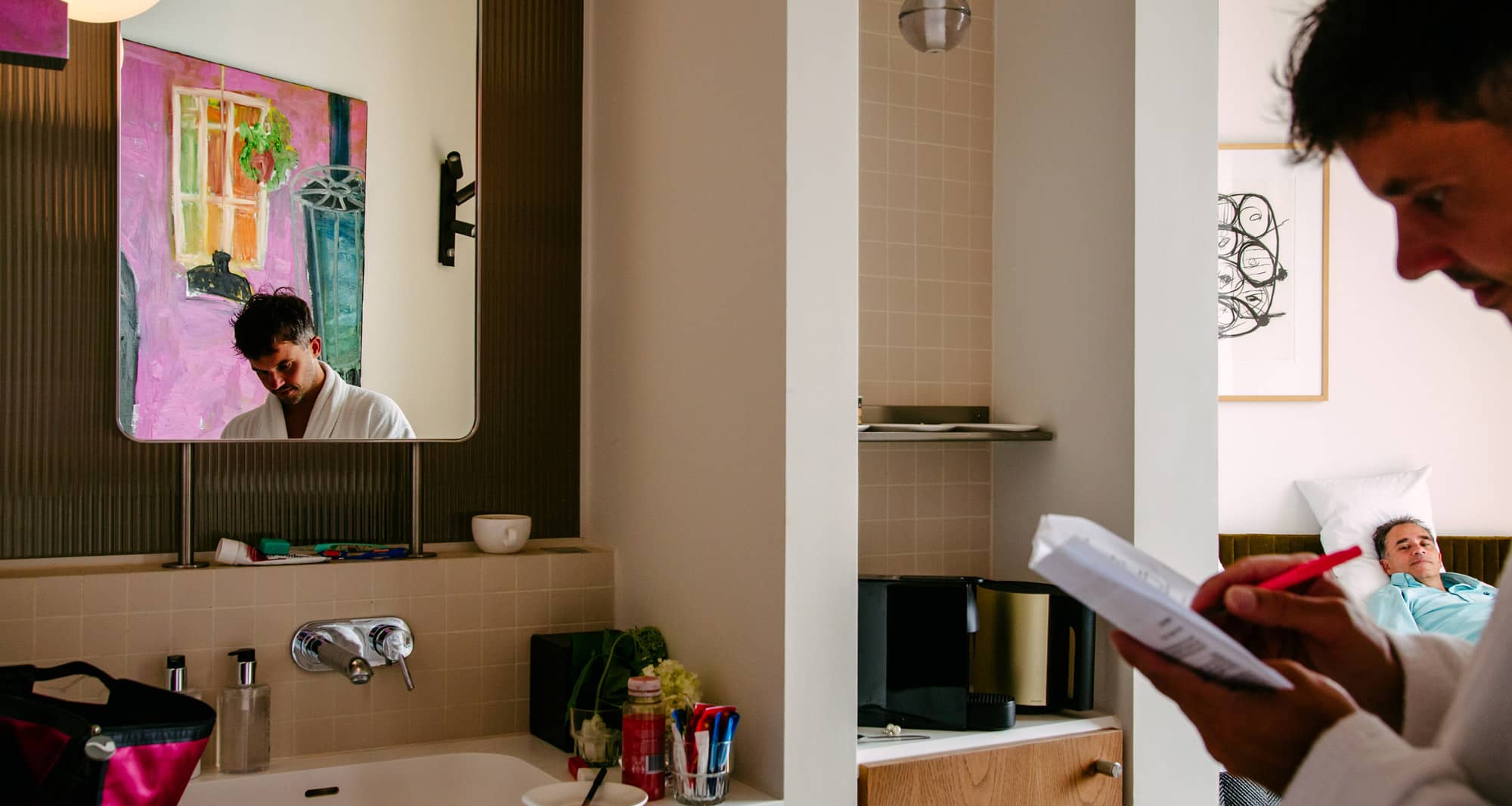 A man immersed in wedding vows, reading a book in a bathroom.