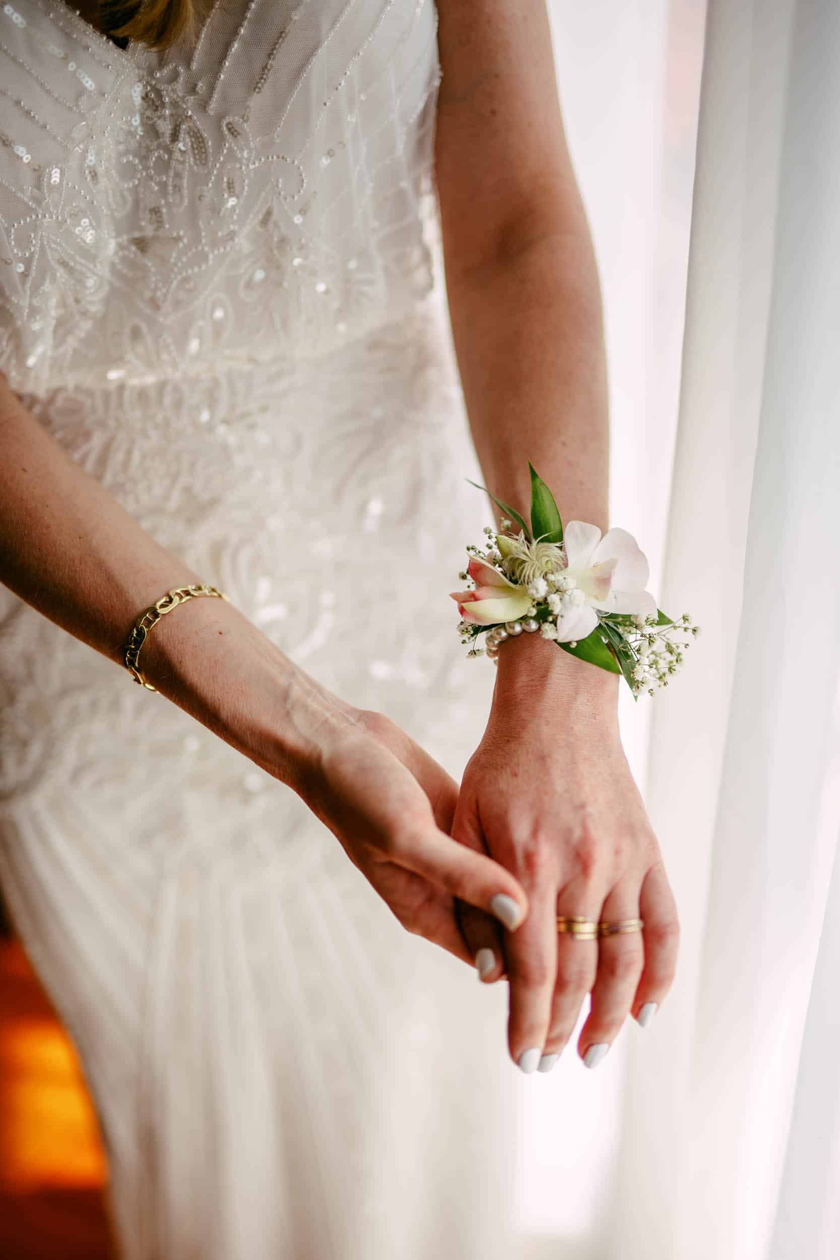 Corsage on the bride's wrist.