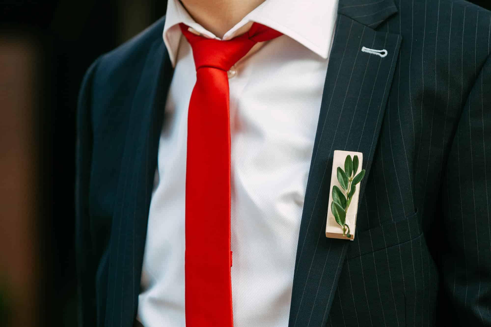 Jenga cubes as a corsage on a suit.
