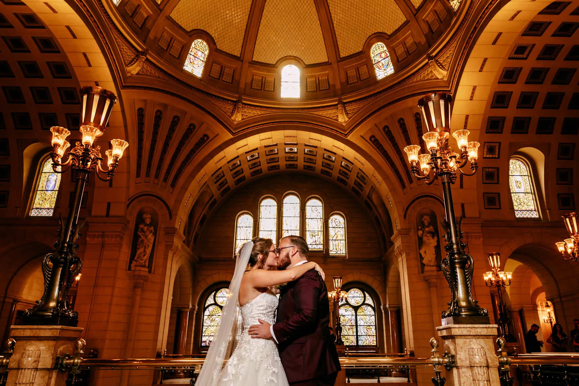 A bride and groom kissing each other passionately during their wedding ceremony in a charming church in Rotterdam.