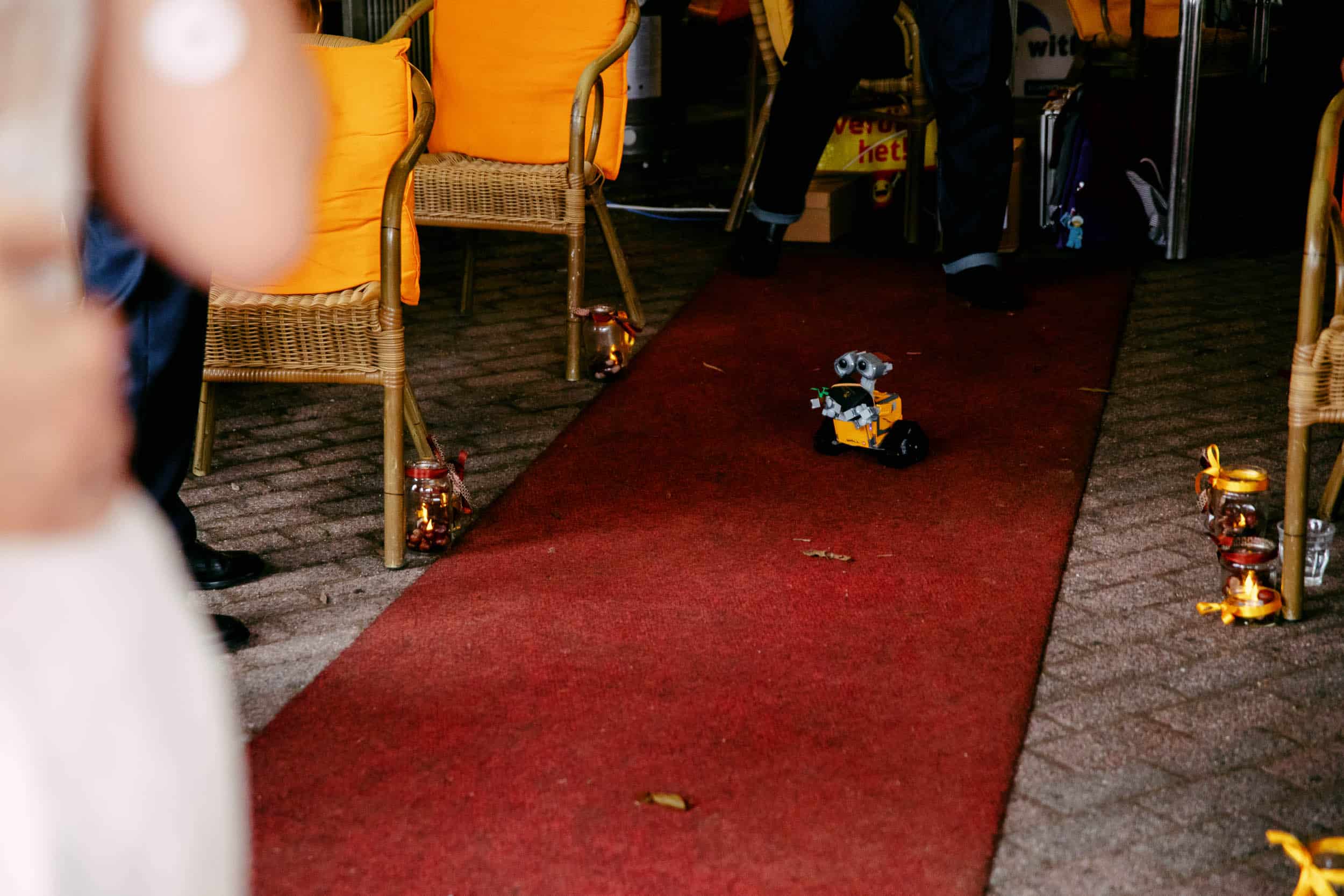 A toy car on a red carpet at a wedding-themed wedding.
