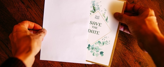 Save the date card opening with hands Justin Manders Photography
