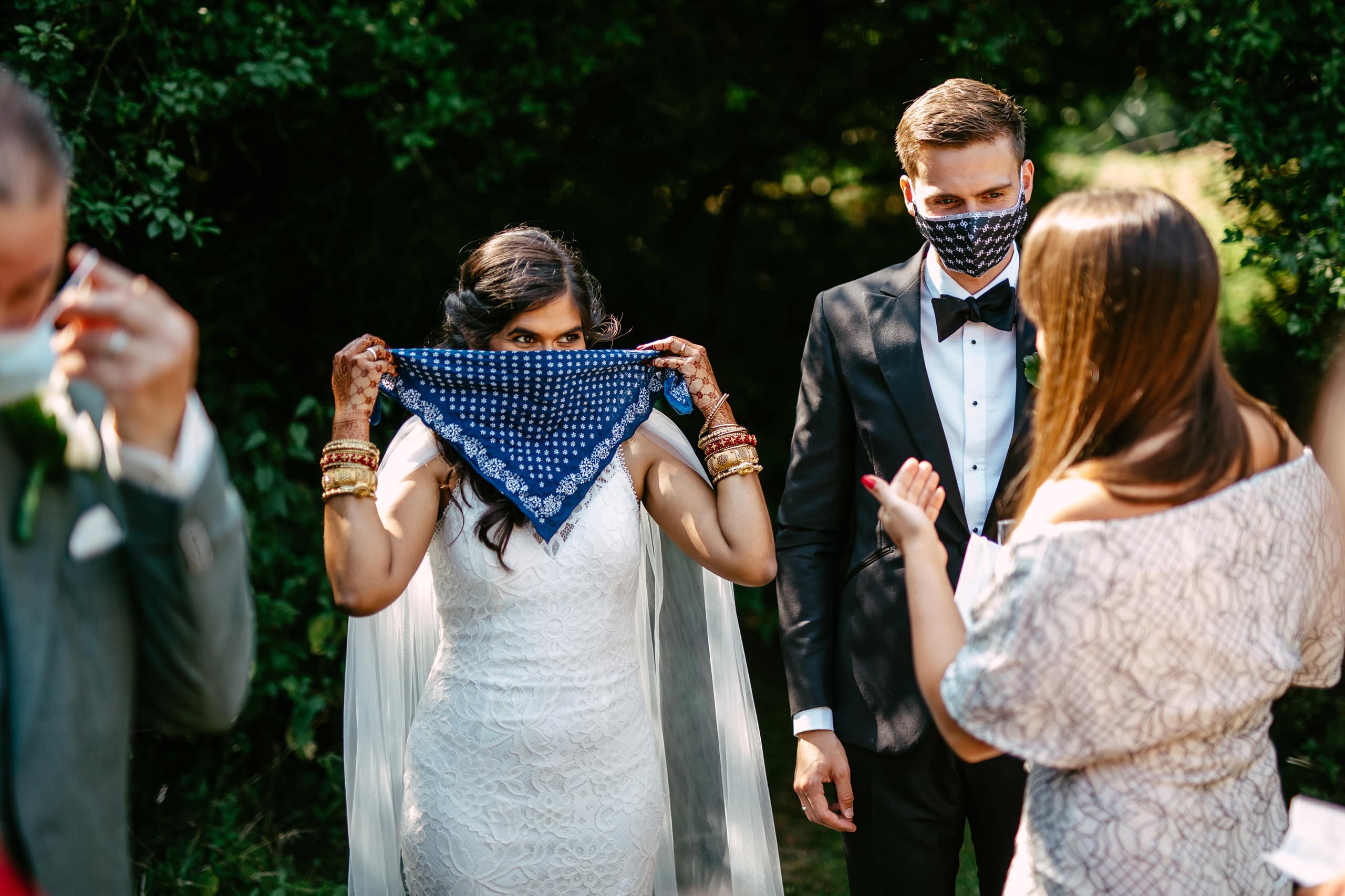 A bride and groom wearing a bandana during their corona wedding ceremony.