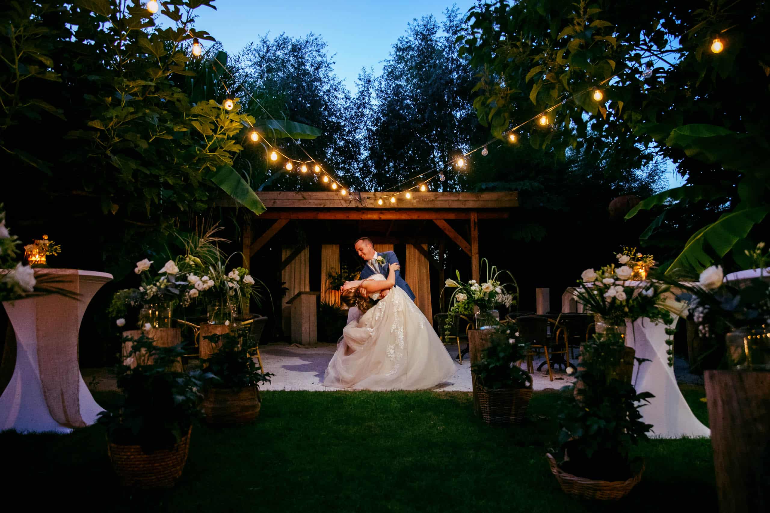 Asking a bride and groom under lights at a wedding venue.
