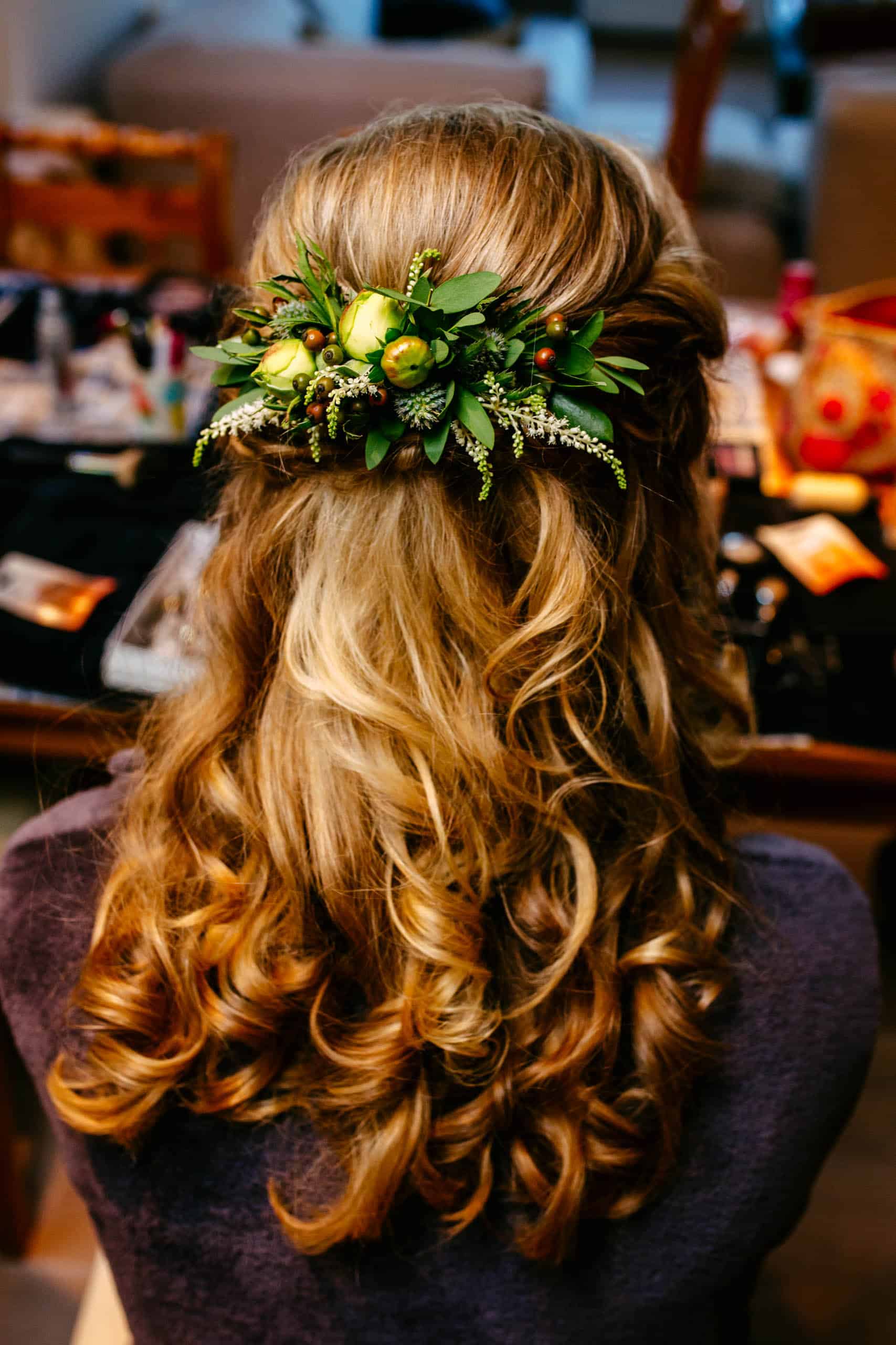 A woman's hair adorned with beautiful bridal hairstyles and flowers.