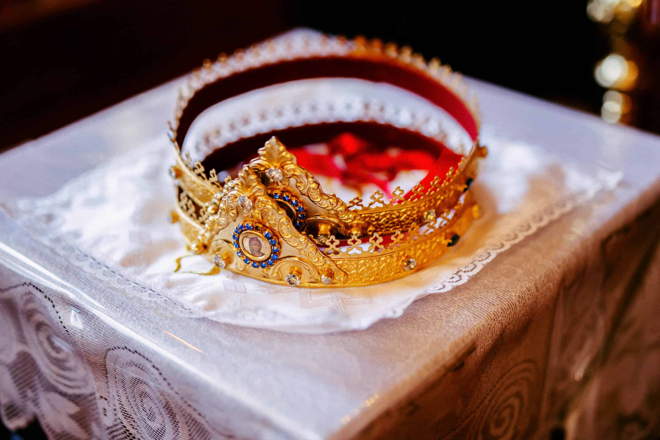 A gold crown with intricate details looks elegant on a table during a Coptic wedding.