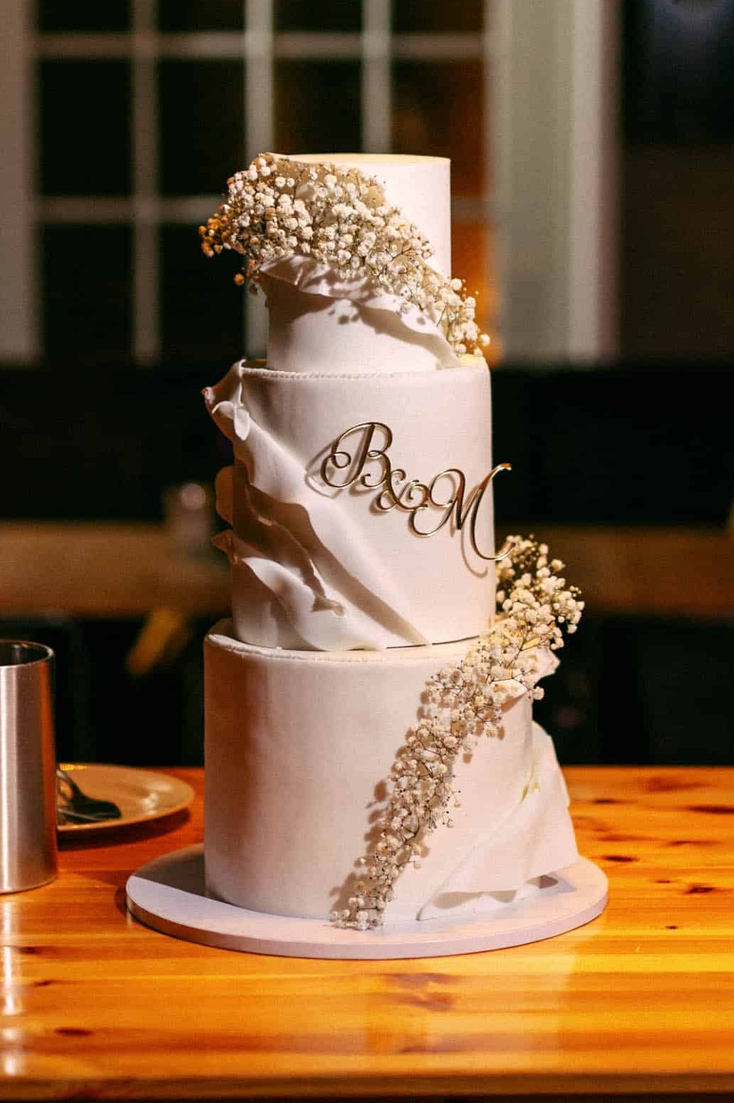A wedding cake on a wooden table.