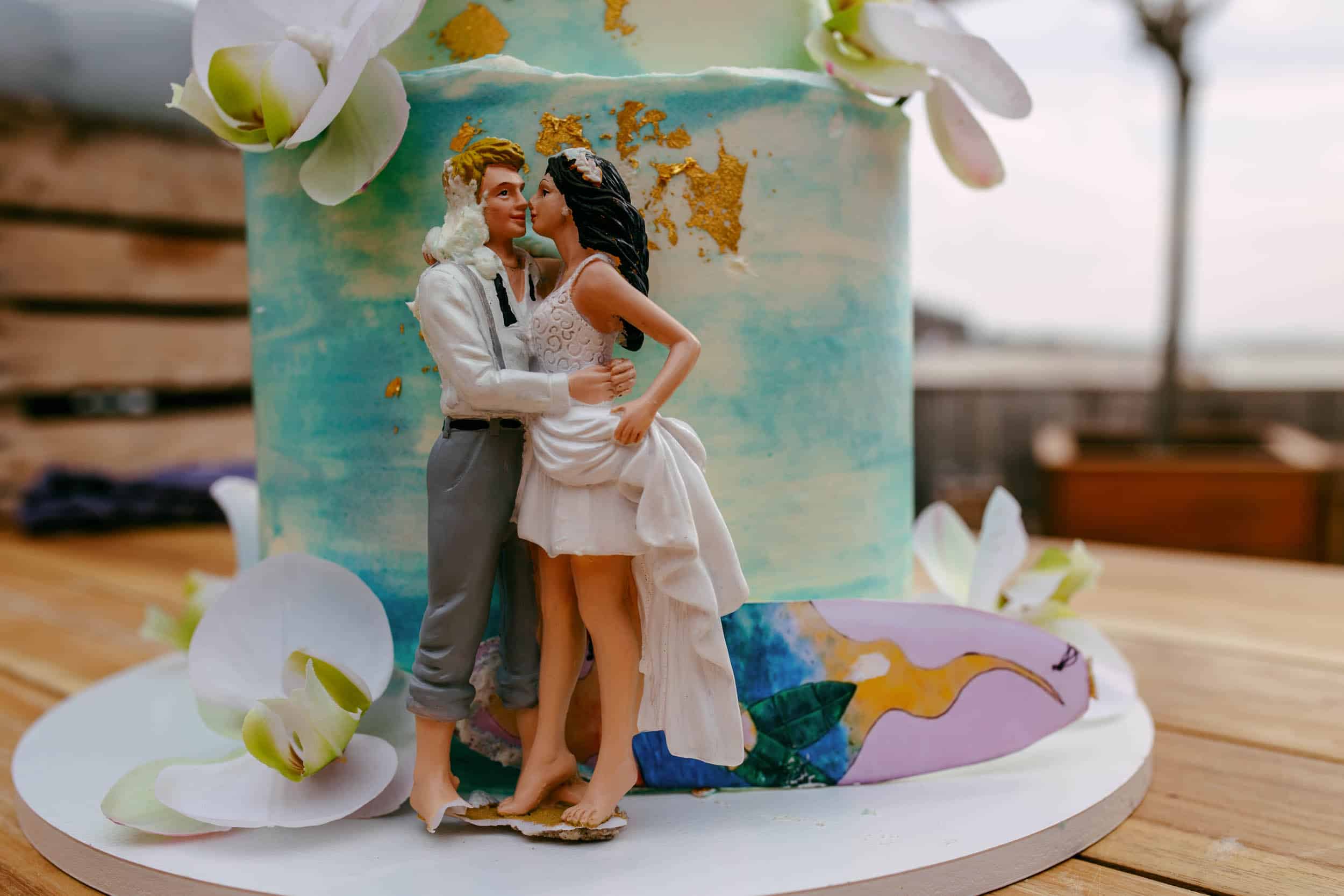 A historically inspired wedding cake with a bride and groom on top.