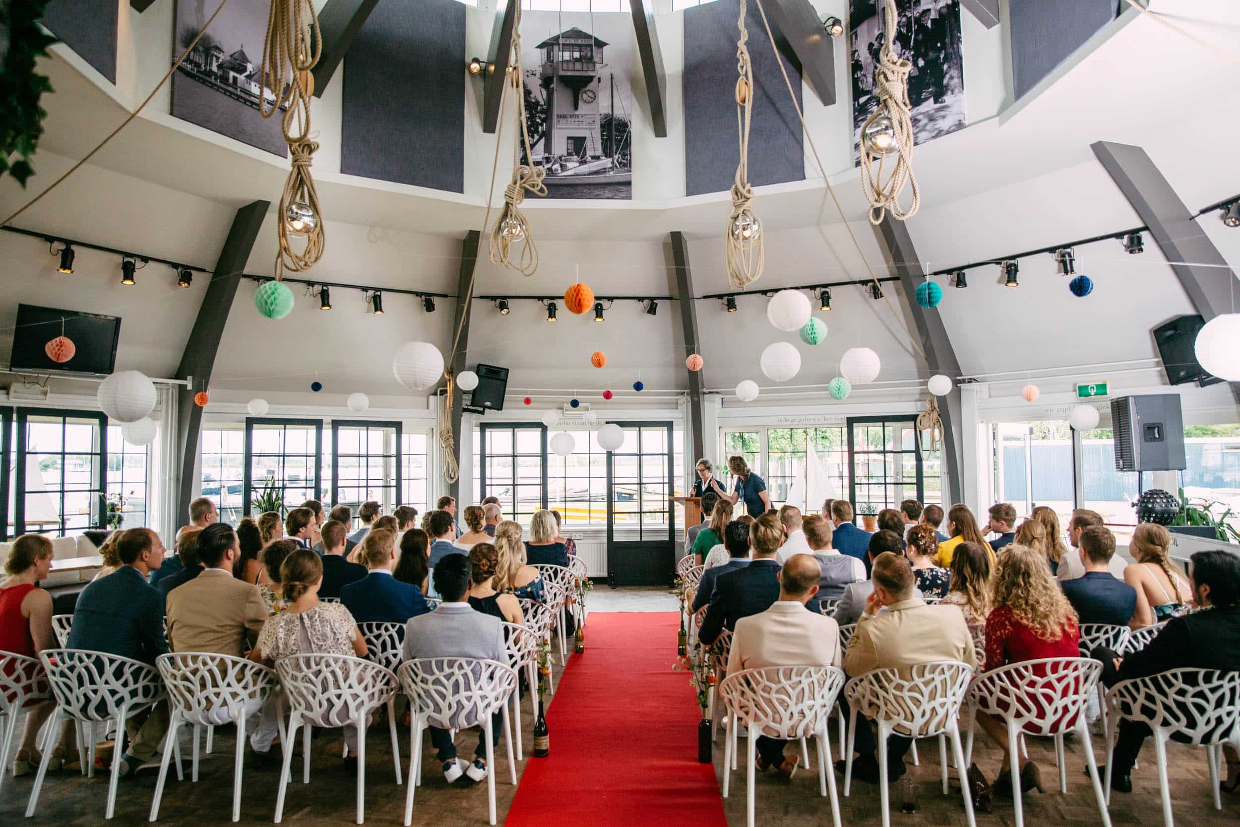 A breathtaking waterfront wedding ceremony at Waterlust the Kaagsociëteit, held in a round room.