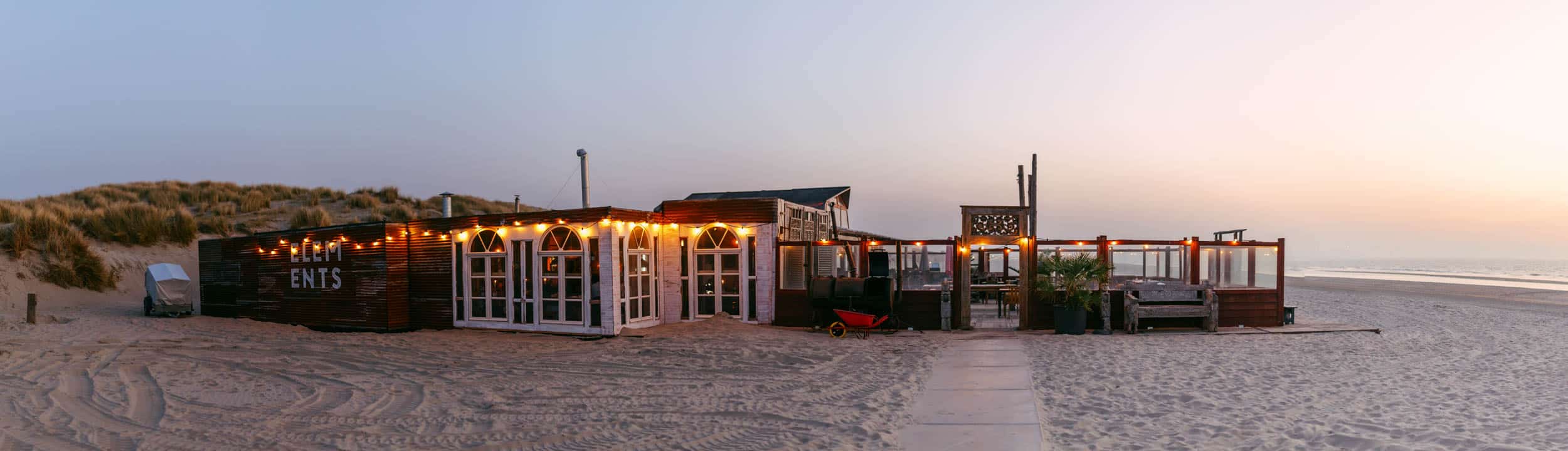 Elements Beach - Een restaurant op het strand in de schemering.