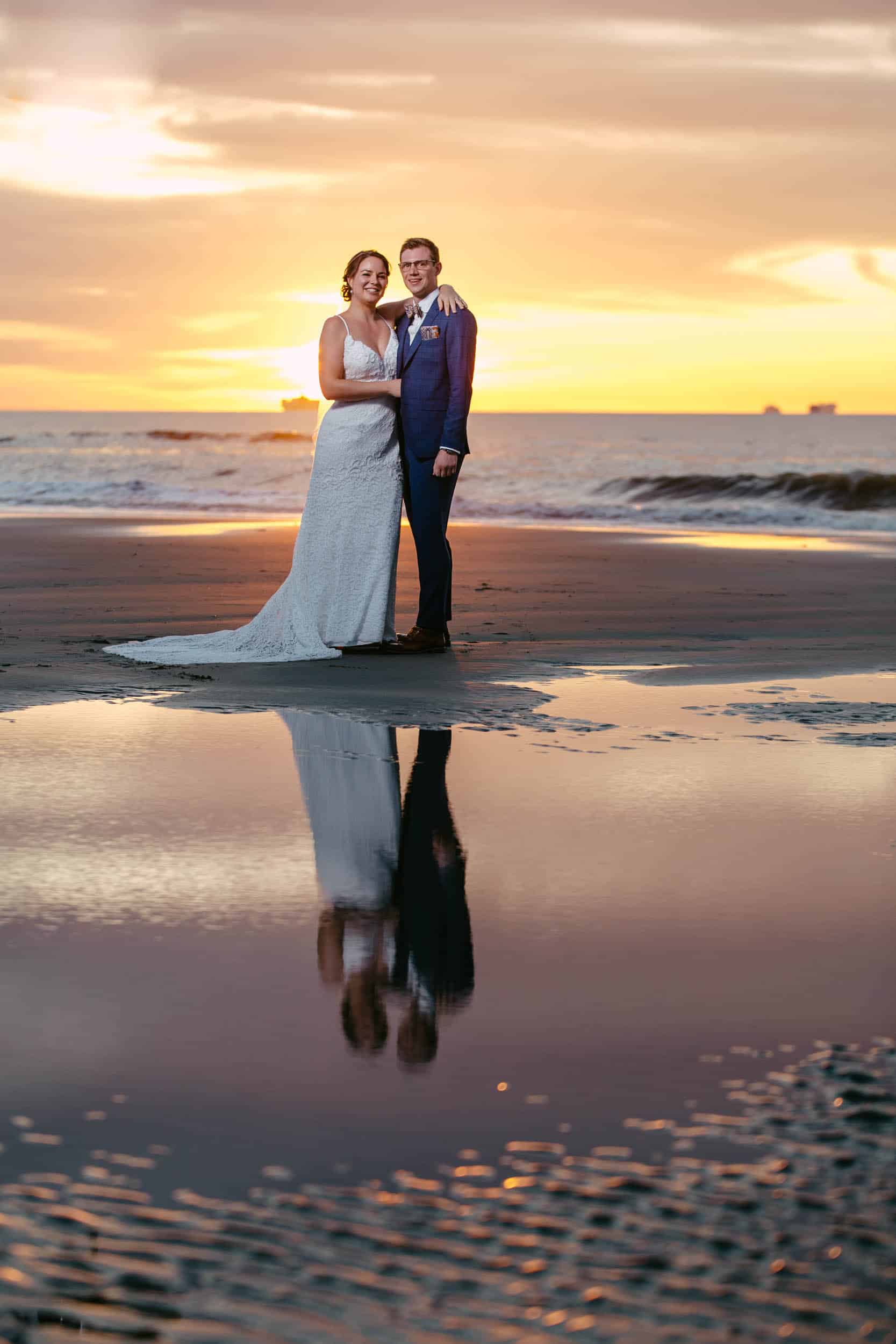 Nature elements captured as bride and groom say their vows at sunset on the sandy beach.