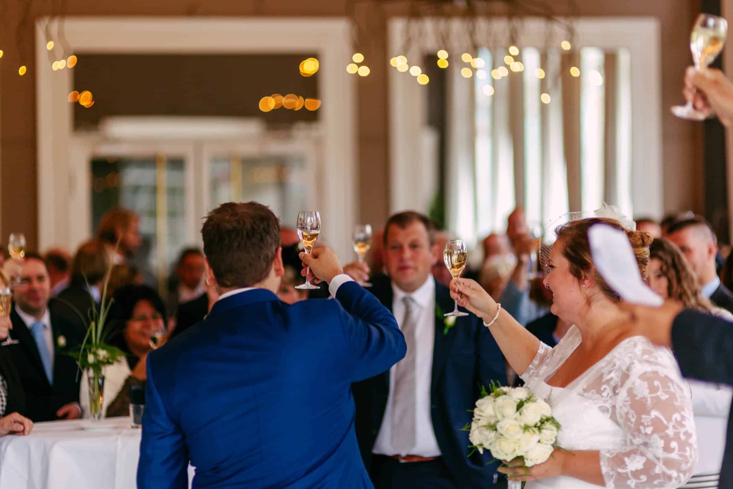 A bride and groom toasting during a wedding reception.