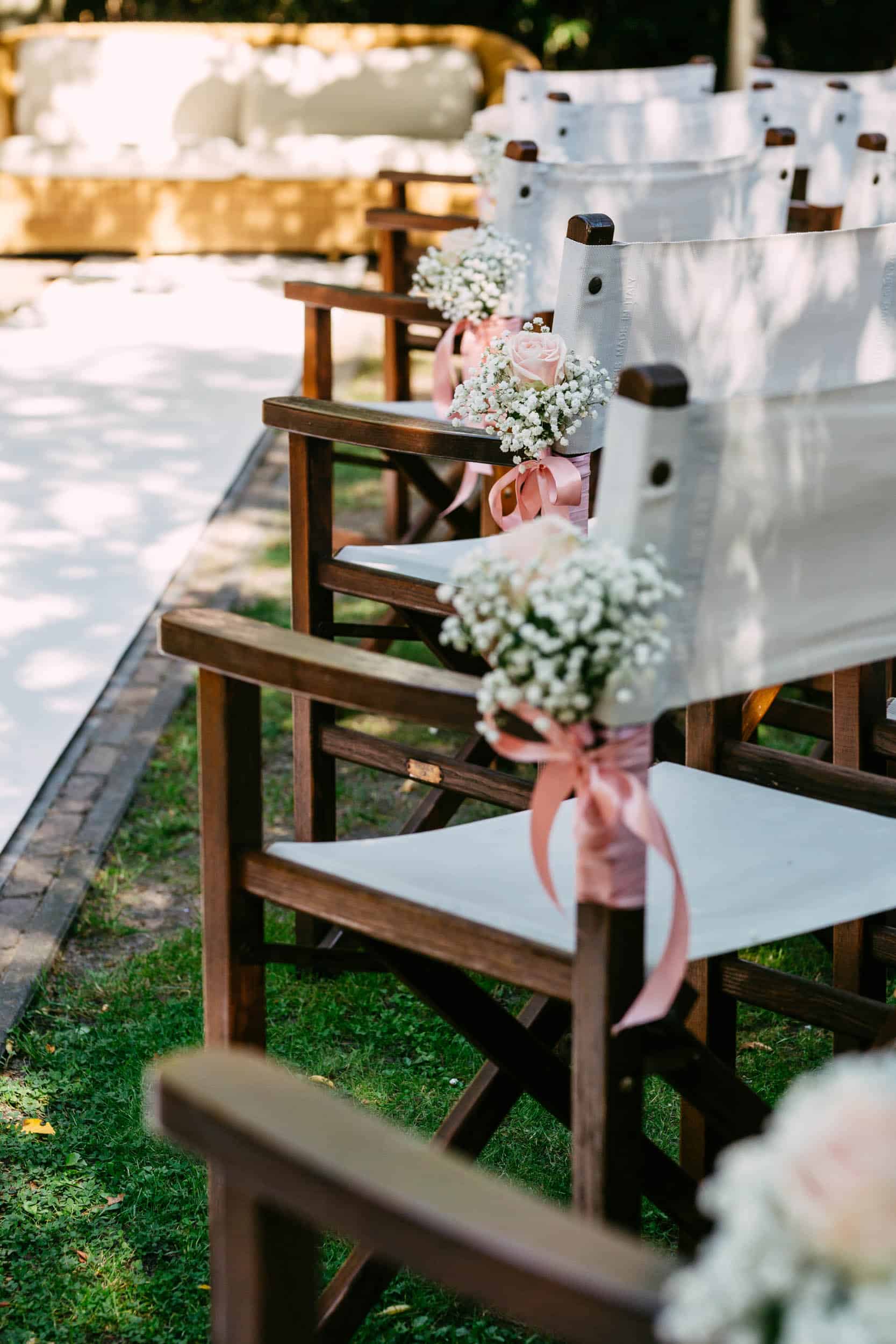 A wedding ceremony set up with white chairs and pink flowers at De Viersprong S Gravenzande.