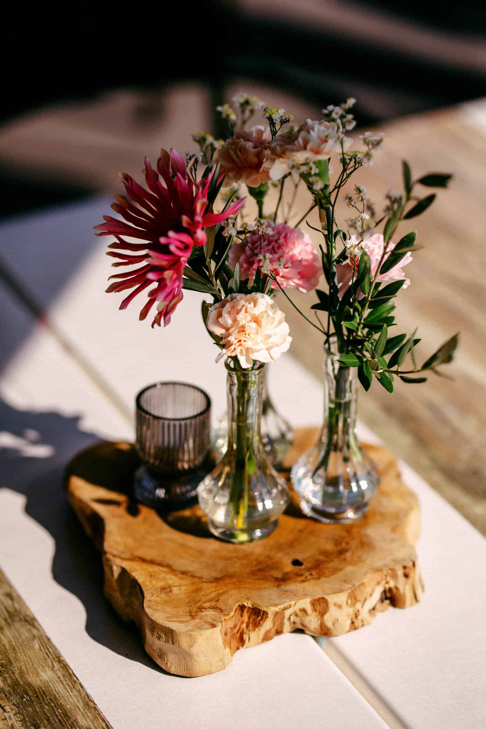 My torpedo shed is a wooden table with vases with flowers on it.