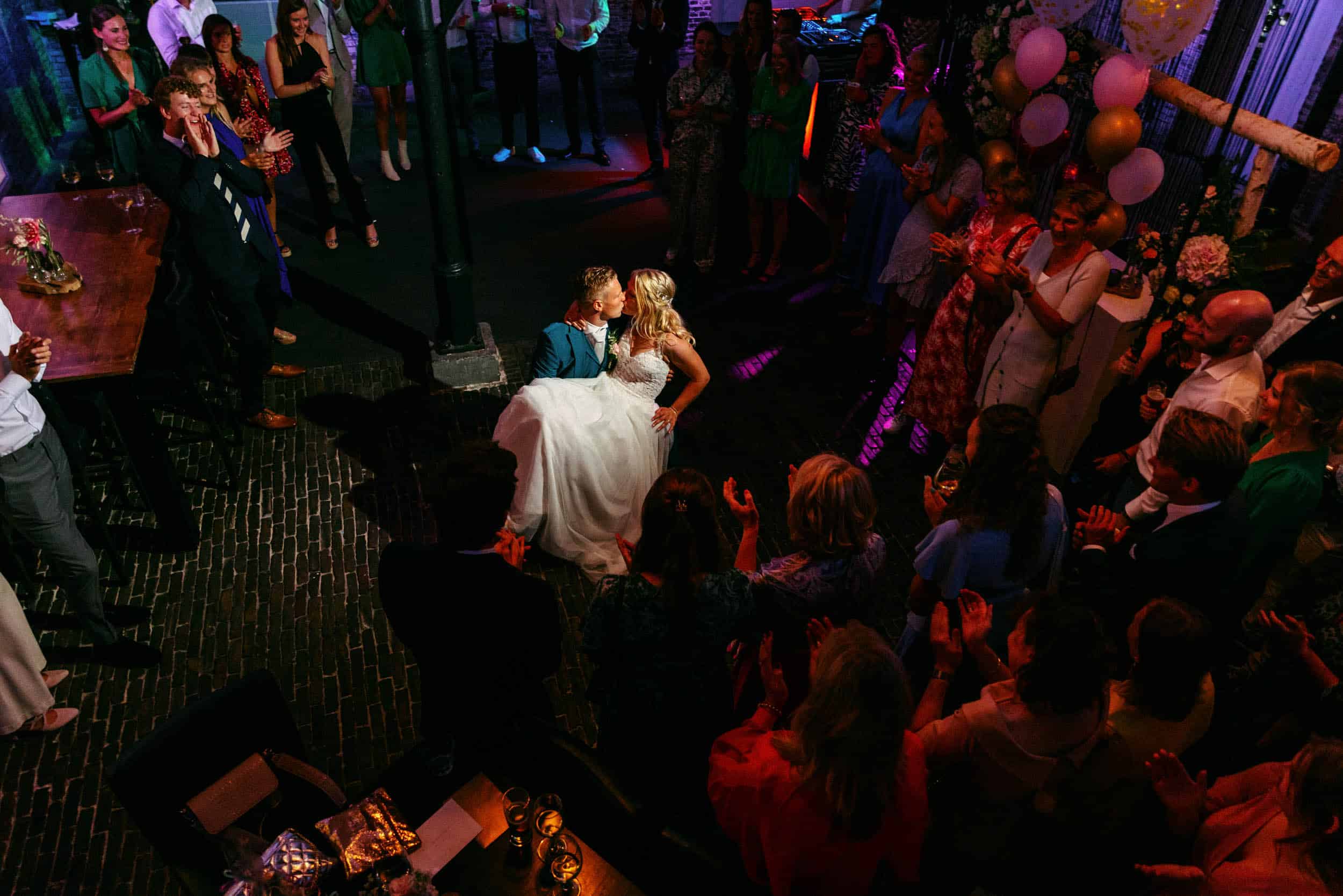 A bride and groom at a wedding party in a bar.