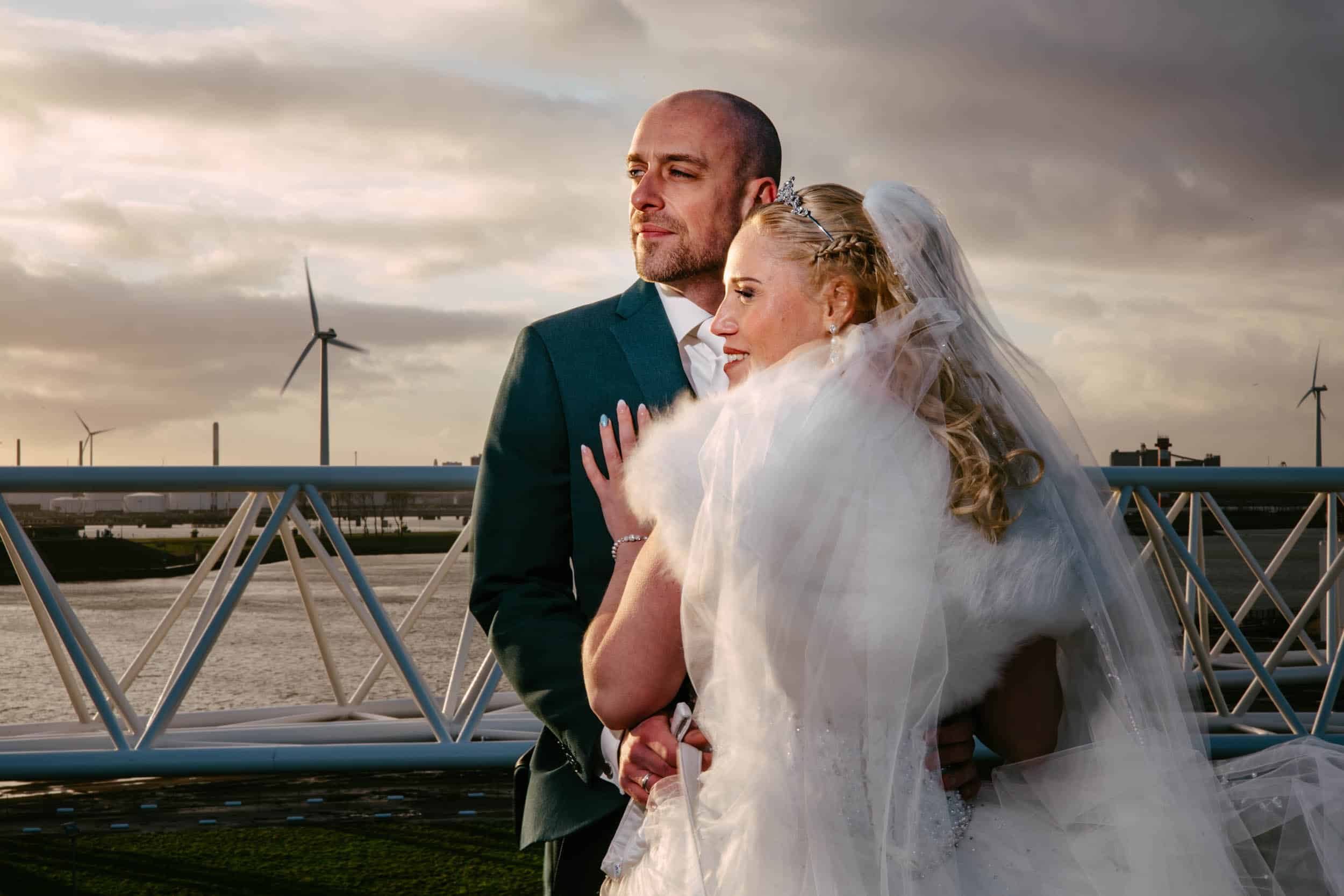 A wedding couple pose in front of the wind turbines at My torpedo shed.