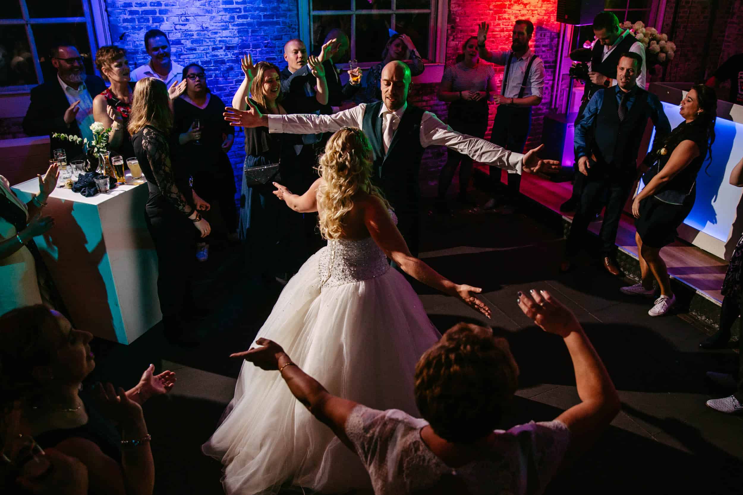 A bride and groom dance at a wedding party.