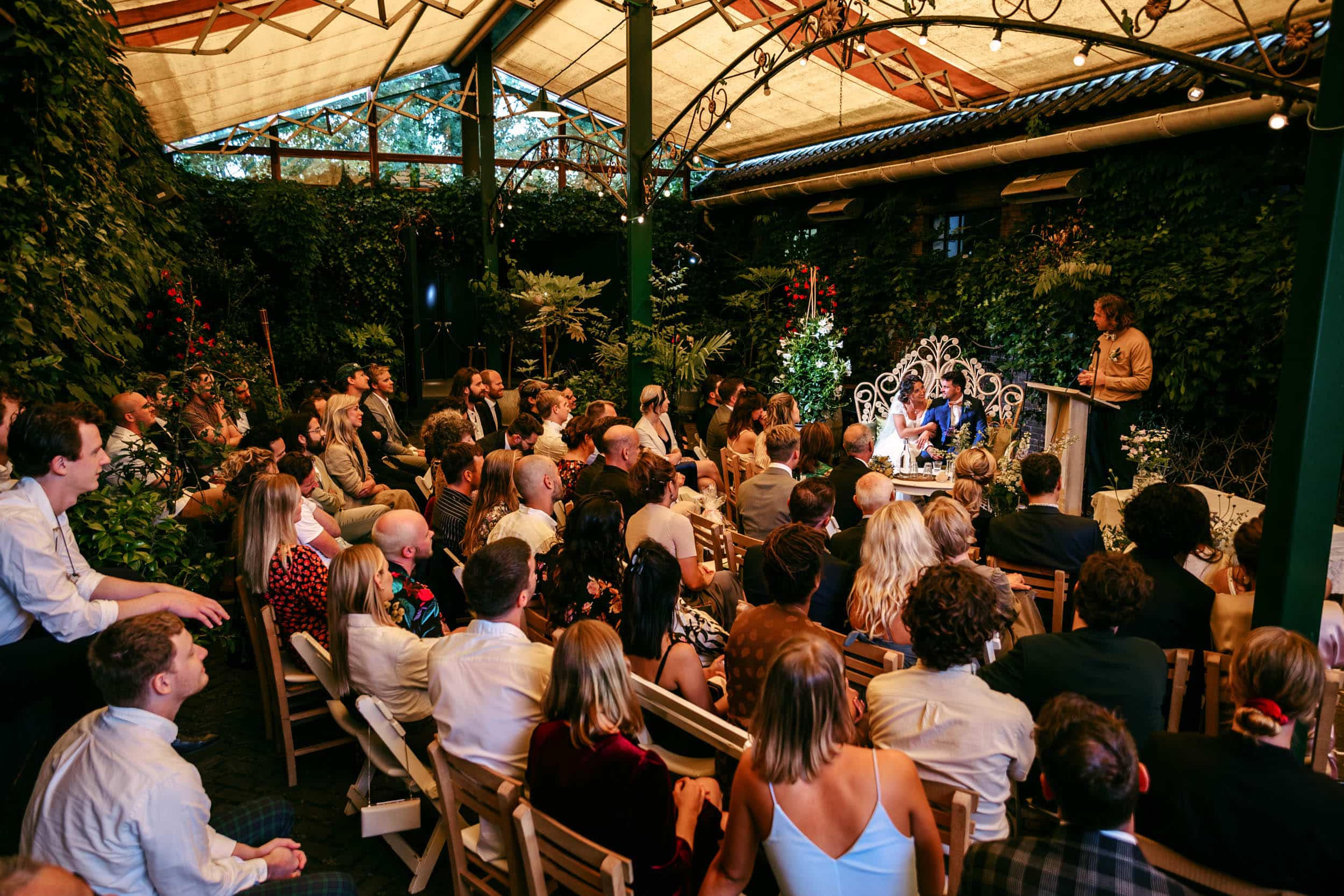 A wedding ceremony in a greenhouse.
