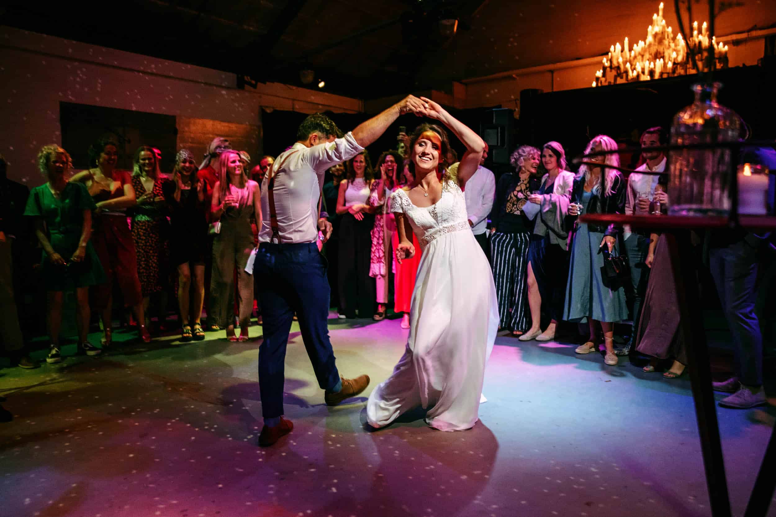 Een bruid en bruidegom dansen op een huwelijksreceptie.