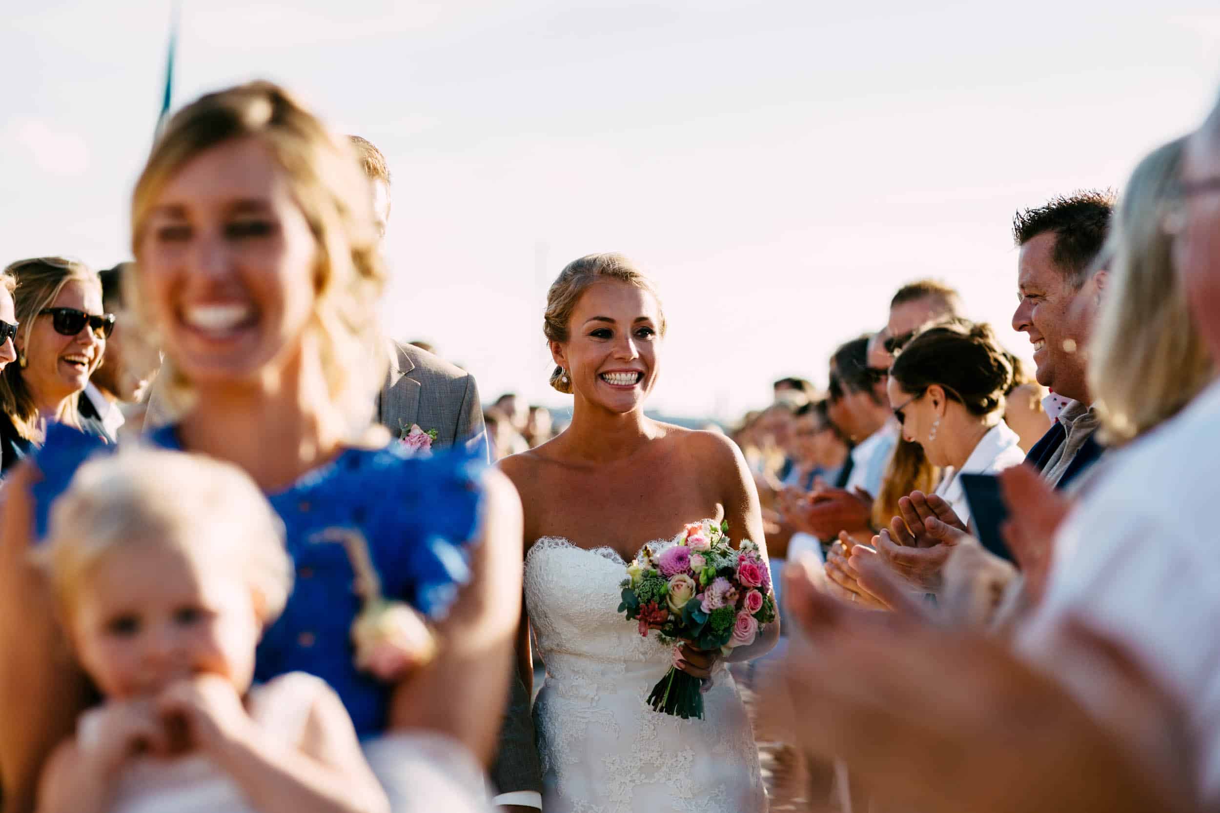 A bride walks down the aisle at a wedding.